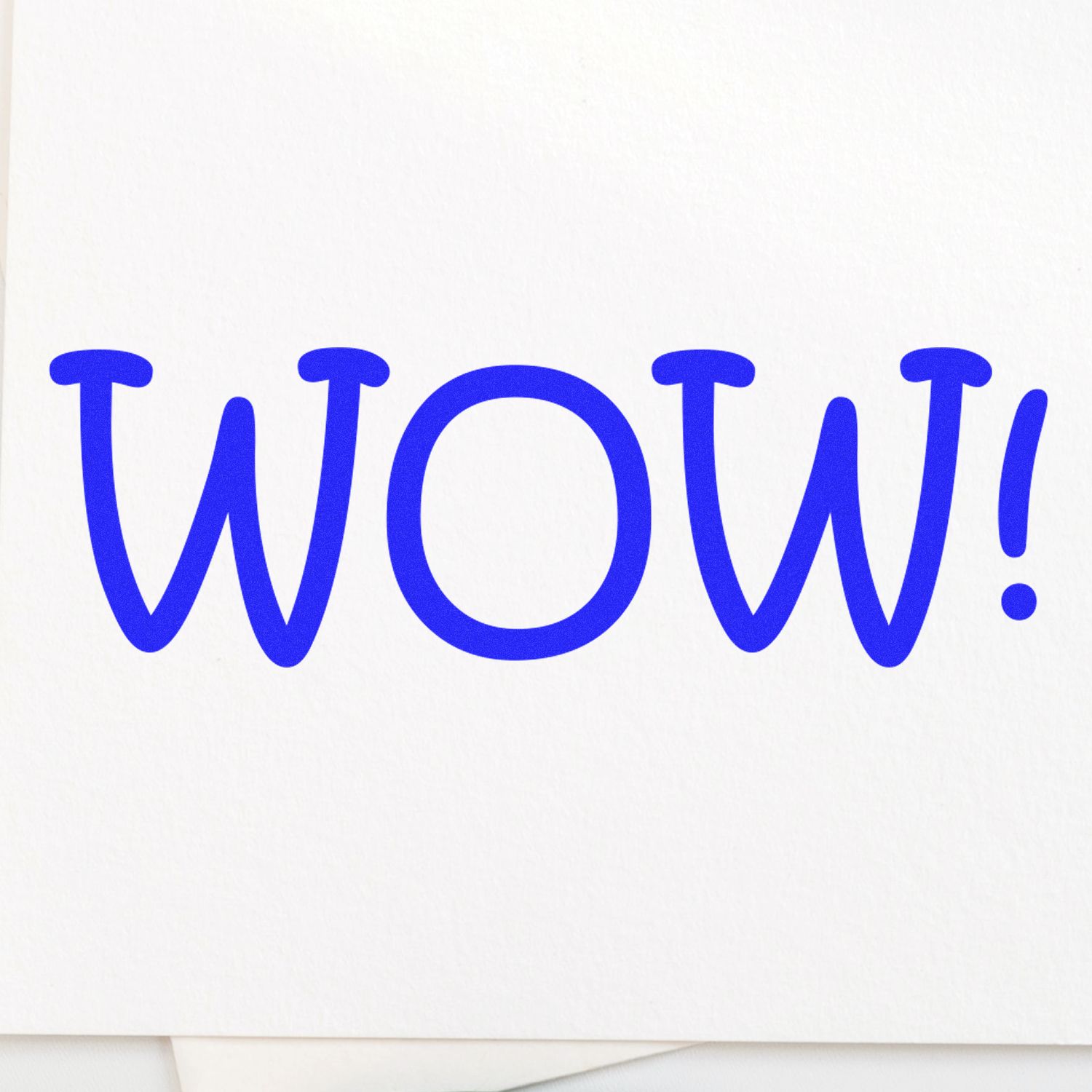 Large WOW Rubber Stamp in blue ink on white paper, showcasing the word WOW! in bold, playful font.