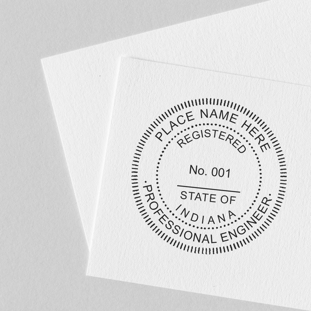 A lifestyle photo showing a stamped image of the Slim Pre-Inked Indiana Professional Engineer Seal Stamp on a piece of paper