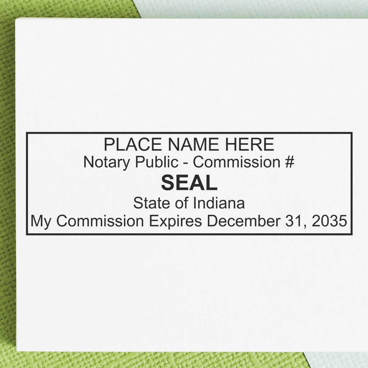A lifestyle photo showing a stamped image of the Heavy-Duty Indiana Rectangular Notary Stamp on a piece of paper