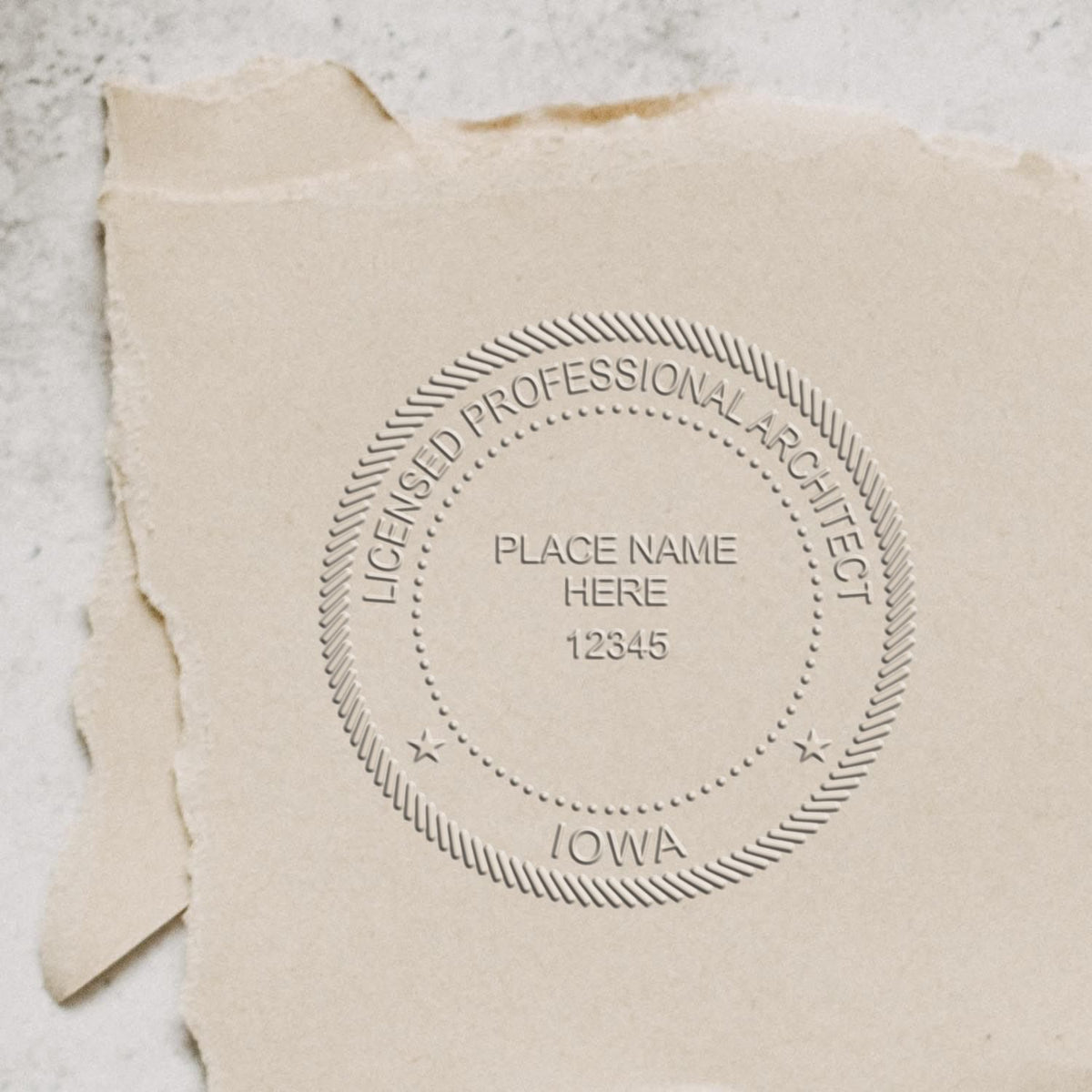 A stamped impression of the Handheld Iowa Architect Seal Embosser in this stylish lifestyle photo, setting the tone for a unique and personalized product.