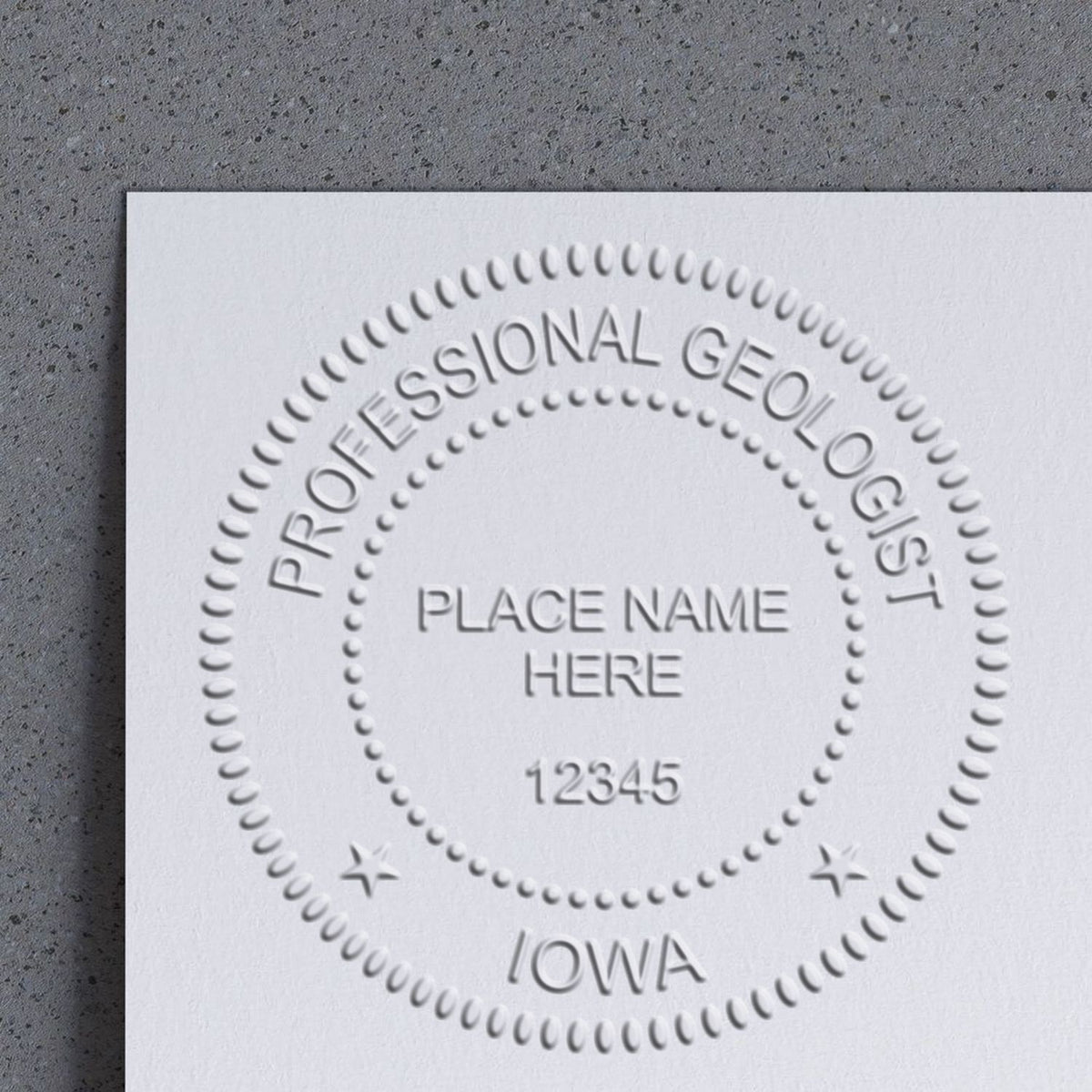 An in use photo of the Hybrid Iowa Geologist Seal showing a sample imprint on a cardstock
