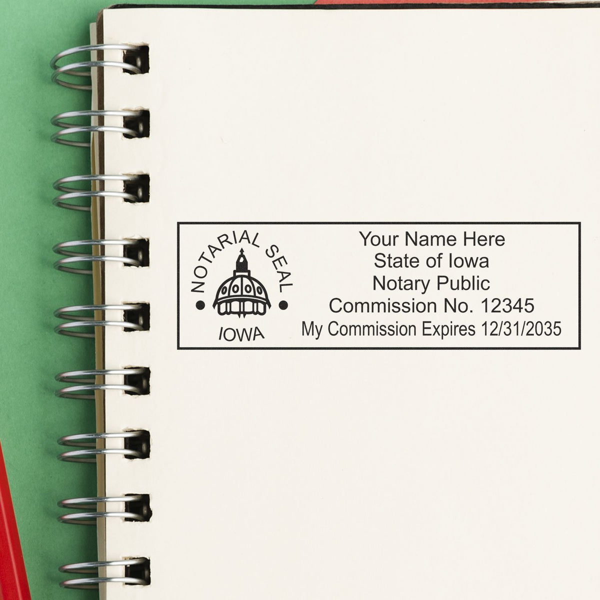 A lifestyle photo showing a stamped image of the Heavy-Duty Iowa Rectangular Notary Stamp on a piece of paper