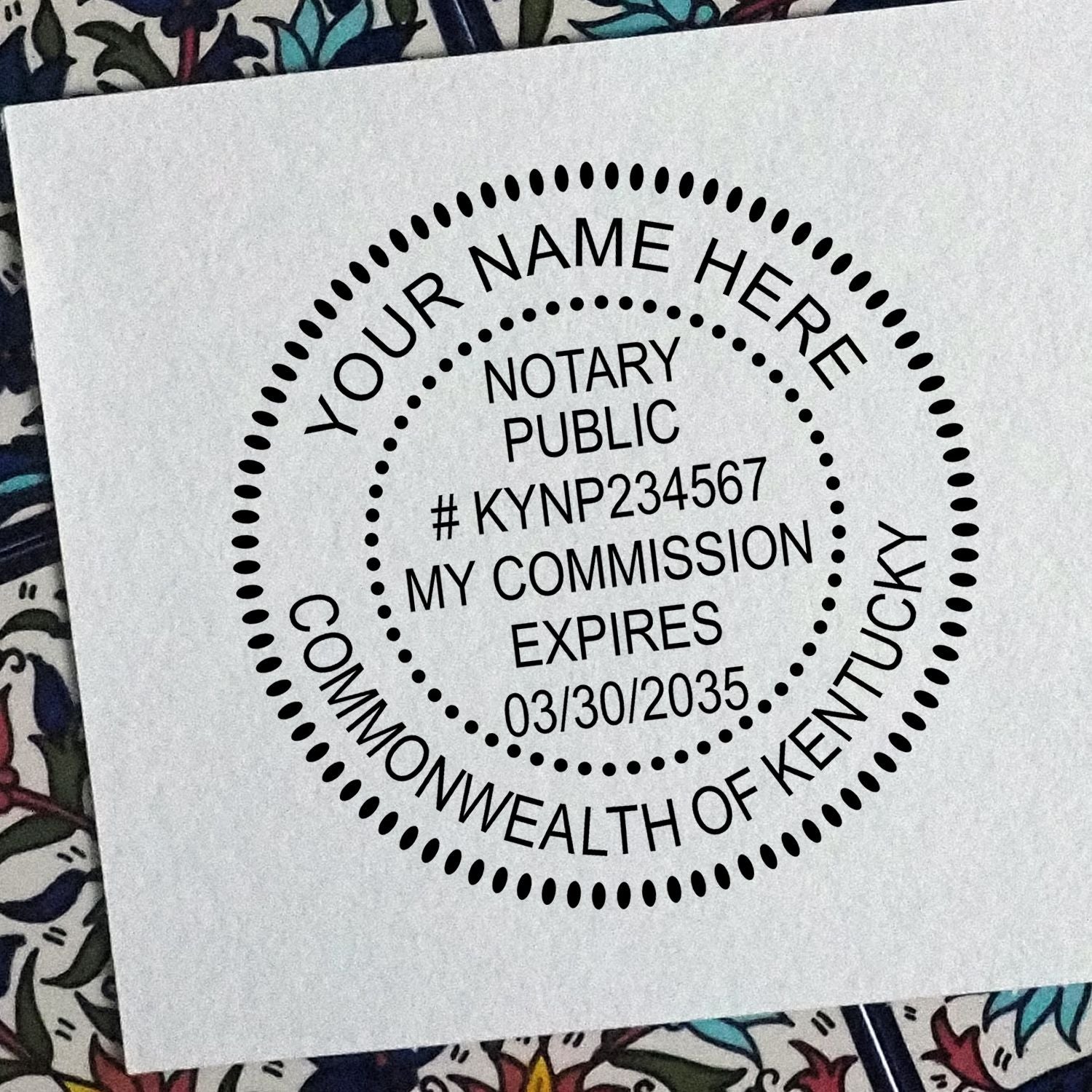 A lifestyle photo showing a stamped image of the Round Kentucky Notary Public Seal Stamp on a piece of paper