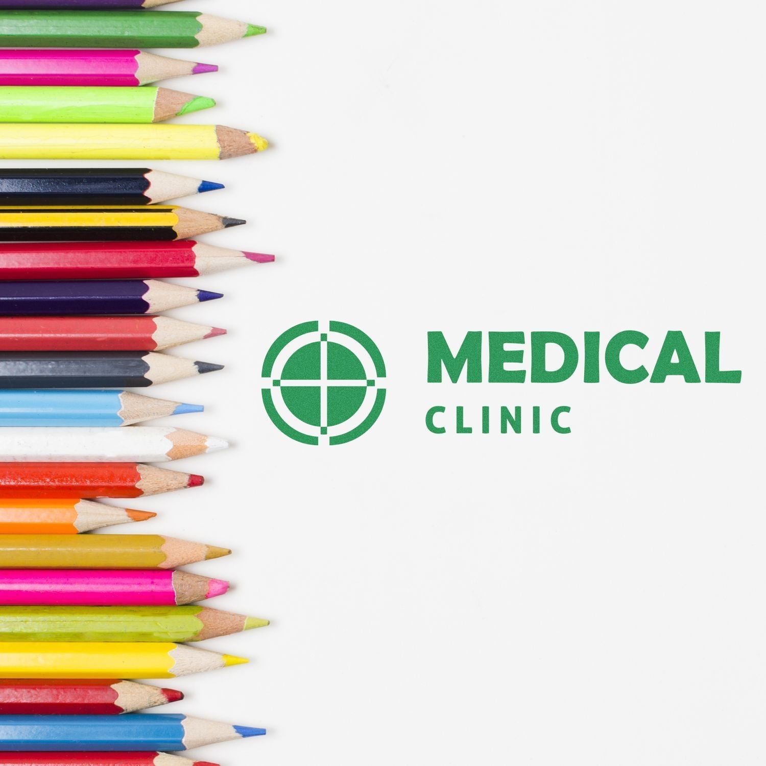 Colorful pencils next to a stamped MEDICAL CLINIC logo using the Custom Rubber Stamp Size 2 x 3 on a white background.