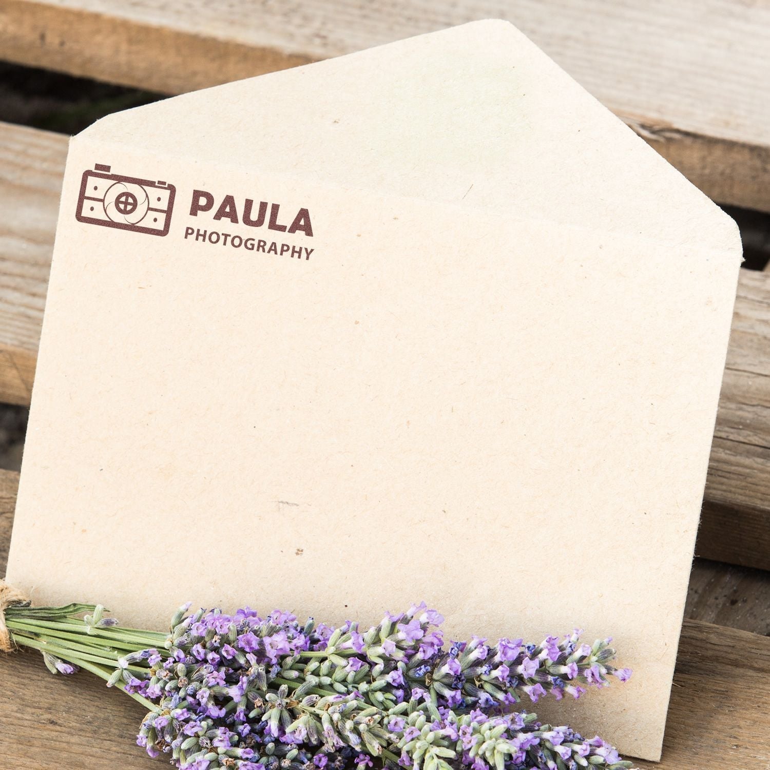 MaxLight XL2-115 Custom Pre-Inked Business Stamp 11/16 x 1-15/16 used on an envelope with a lavender bouquet on a wooden surface.