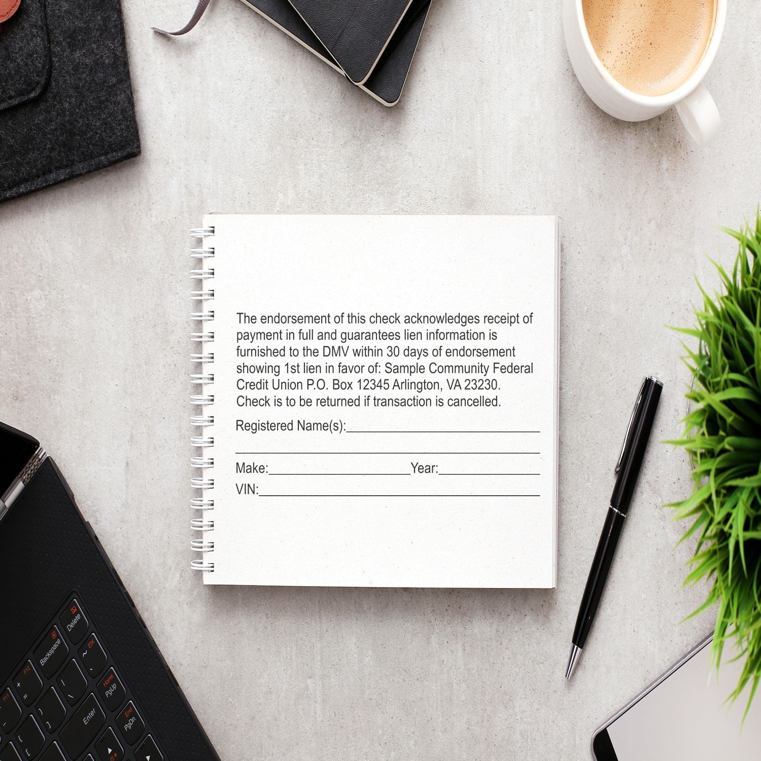 A 10 Line Custom Rubber Stamp with Wood Handle is used on a document, surrounded by a laptop, pen, and plant on a desk.