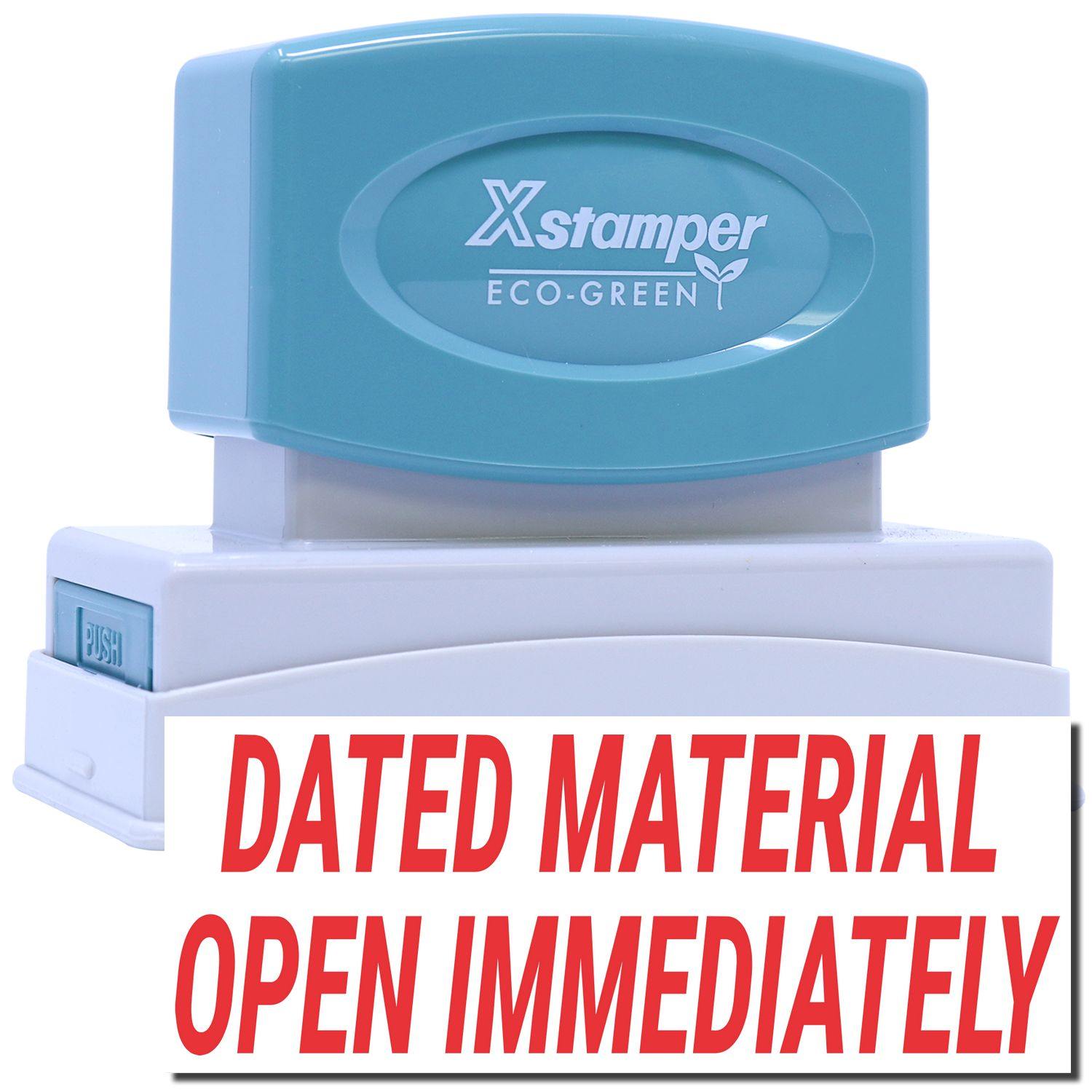 Jumbo Dated Material Open Immediately Xstamper Stamp with a blue handle and white base, featuring bold red text on the stamp.