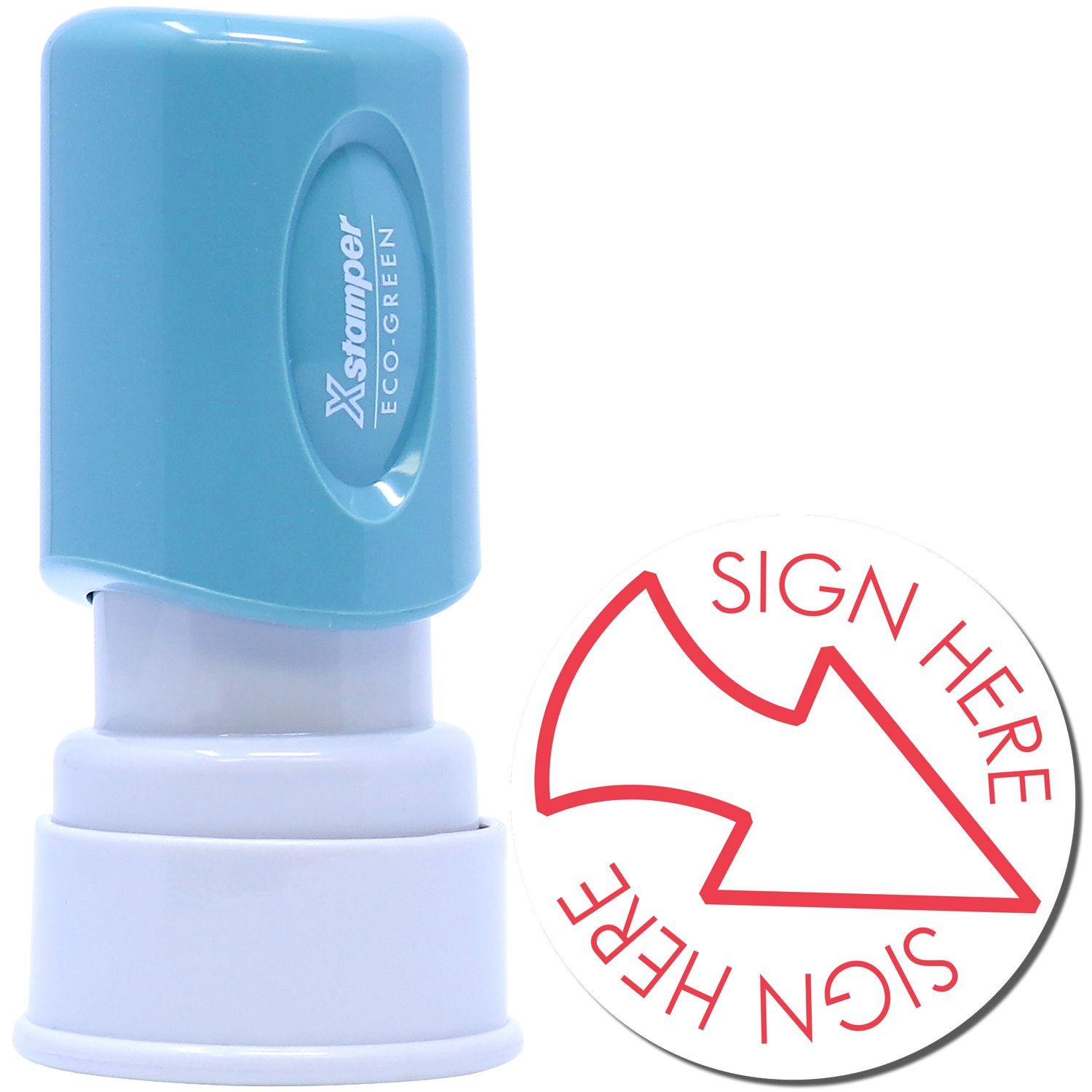 Round Red Sign Here Xstamper Stamp with a blue handle and a red arrow pointing to the text Sign Here on a white circular base.