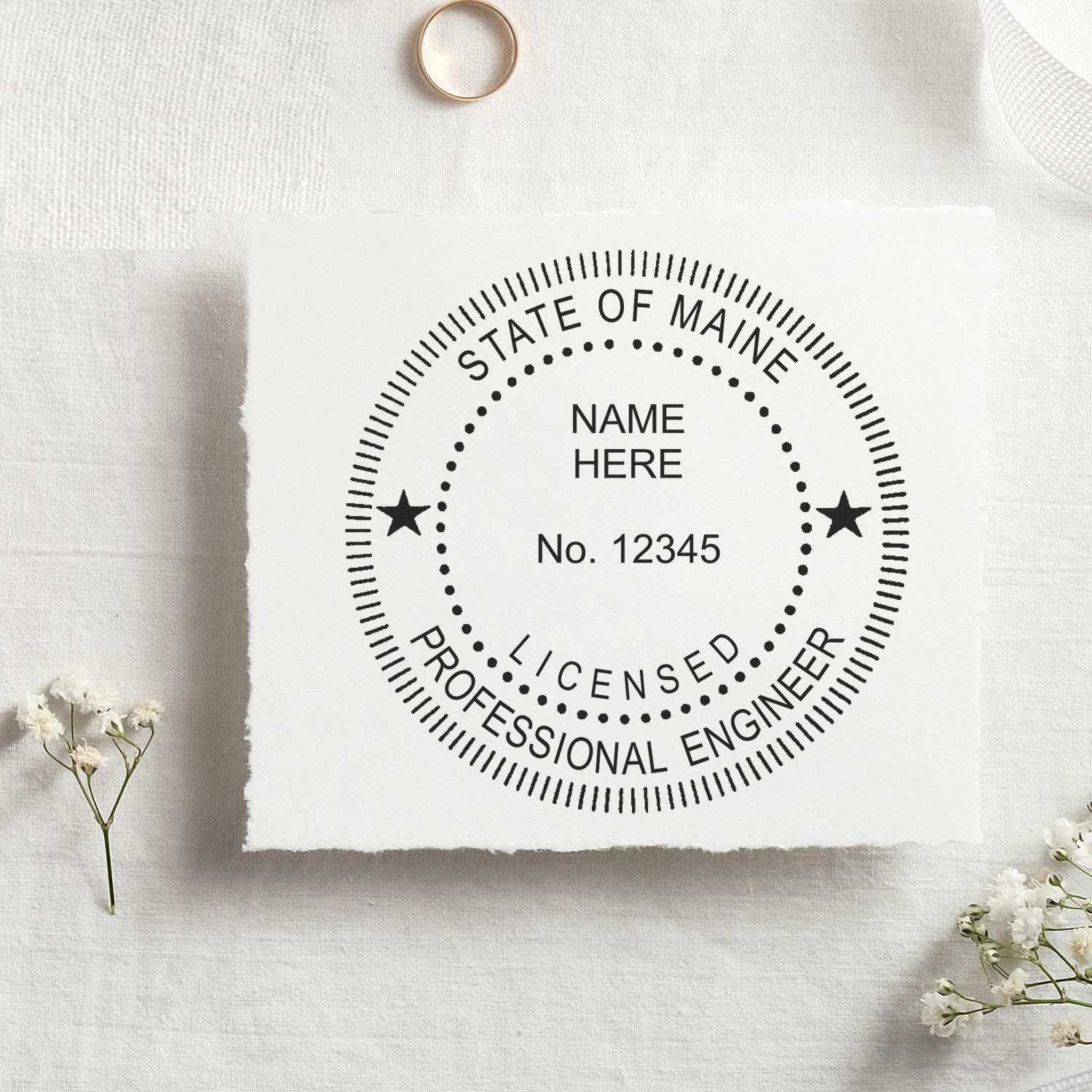 A lifestyle photo showing a stamped image of the Slim Pre-Inked Maine Professional Engineer Seal Stamp on a piece of paper