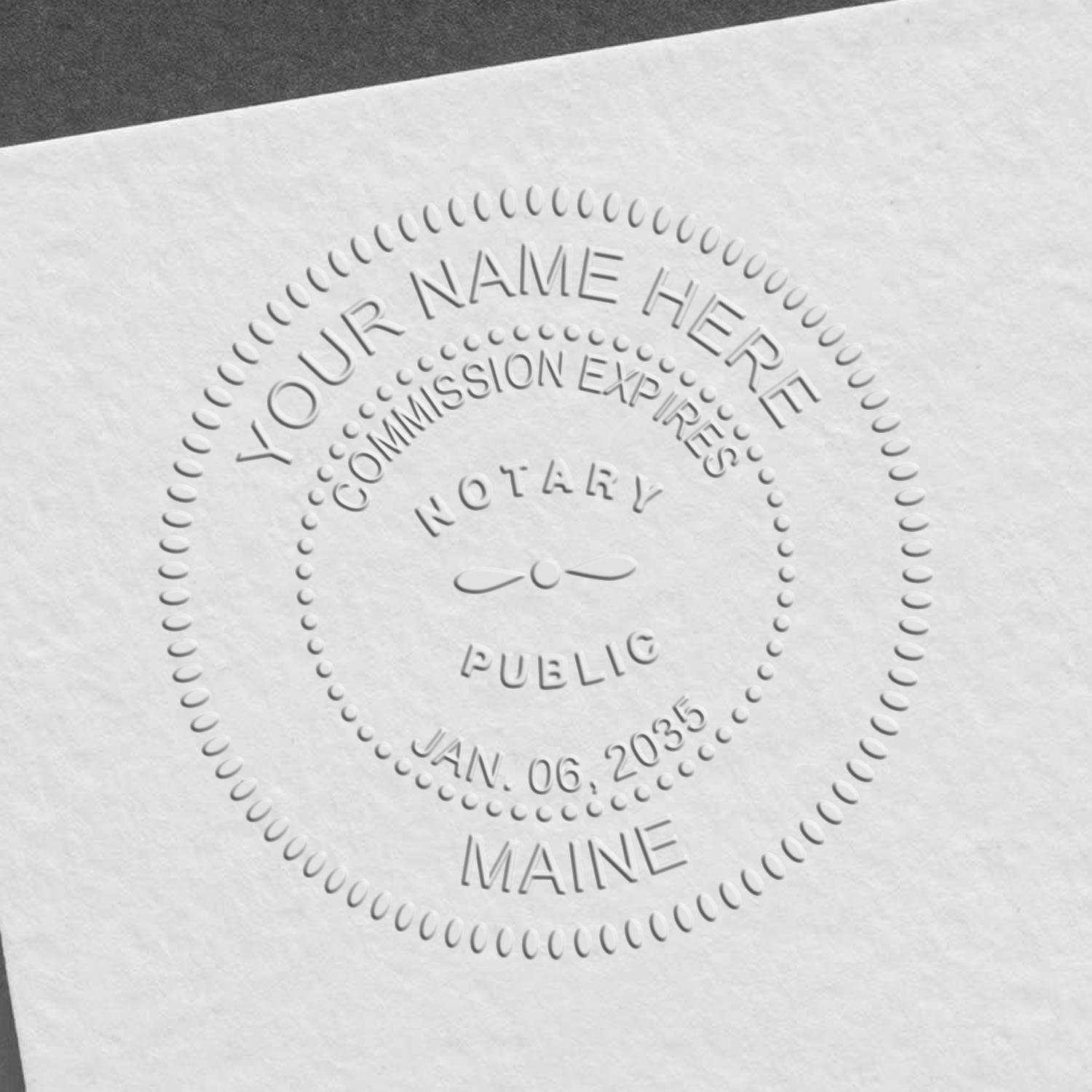 A stamped impression of the Maine Handheld Notary Seal Embosser in this stylish lifestyle photo, setting the tone for a unique and personalized product.