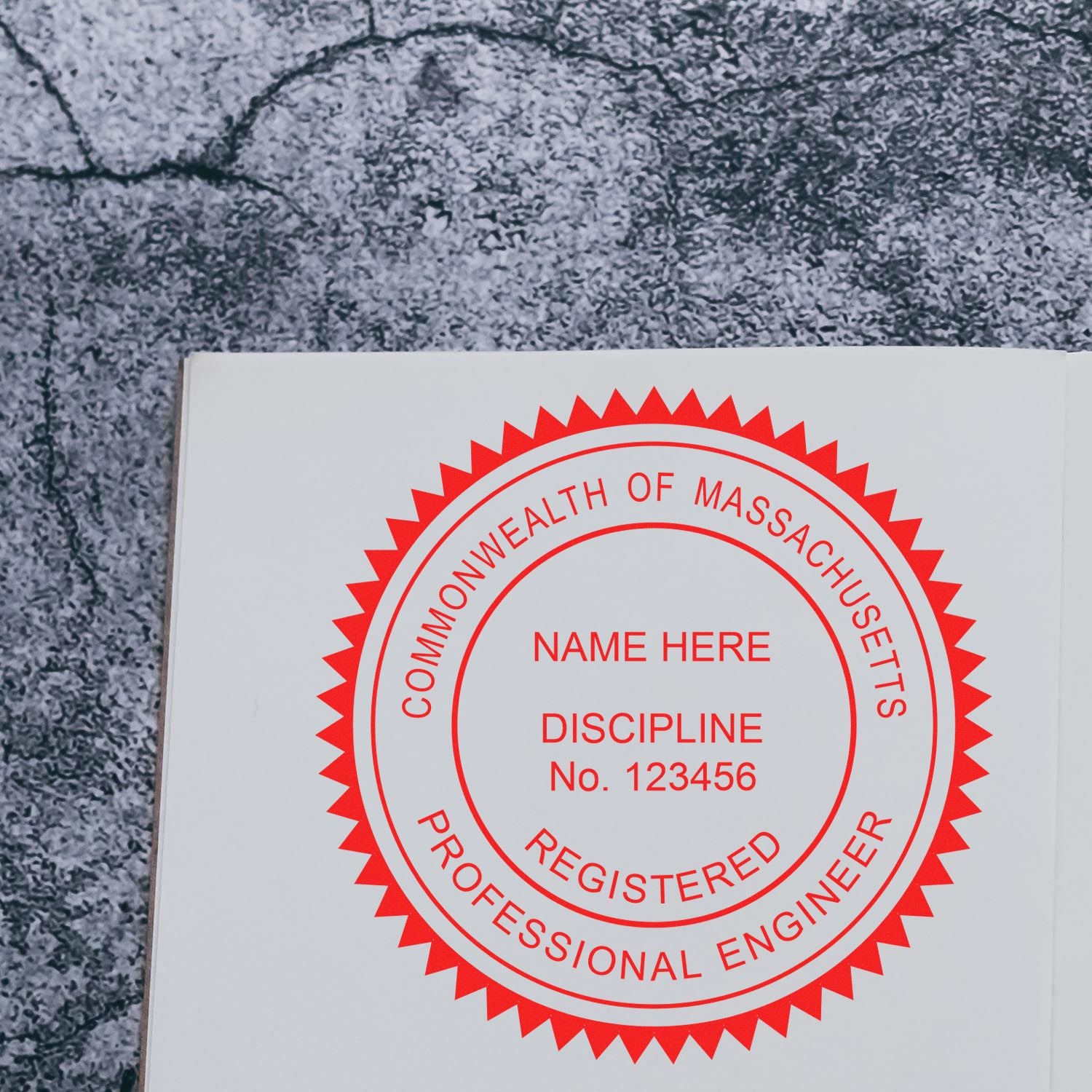 A lifestyle photo showing a stamped image of the Massachusetts Professional Engineer Seal Stamp on a piece of paper