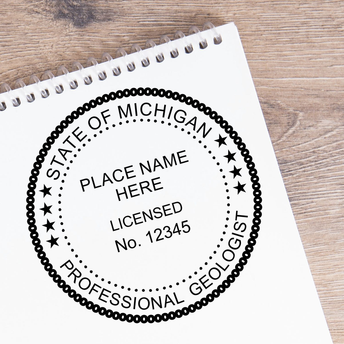 A lifestyle photo showing a stamped image of the Slim Pre-Inked Michigan Professional Geologist Seal Stamp on a piece of paper