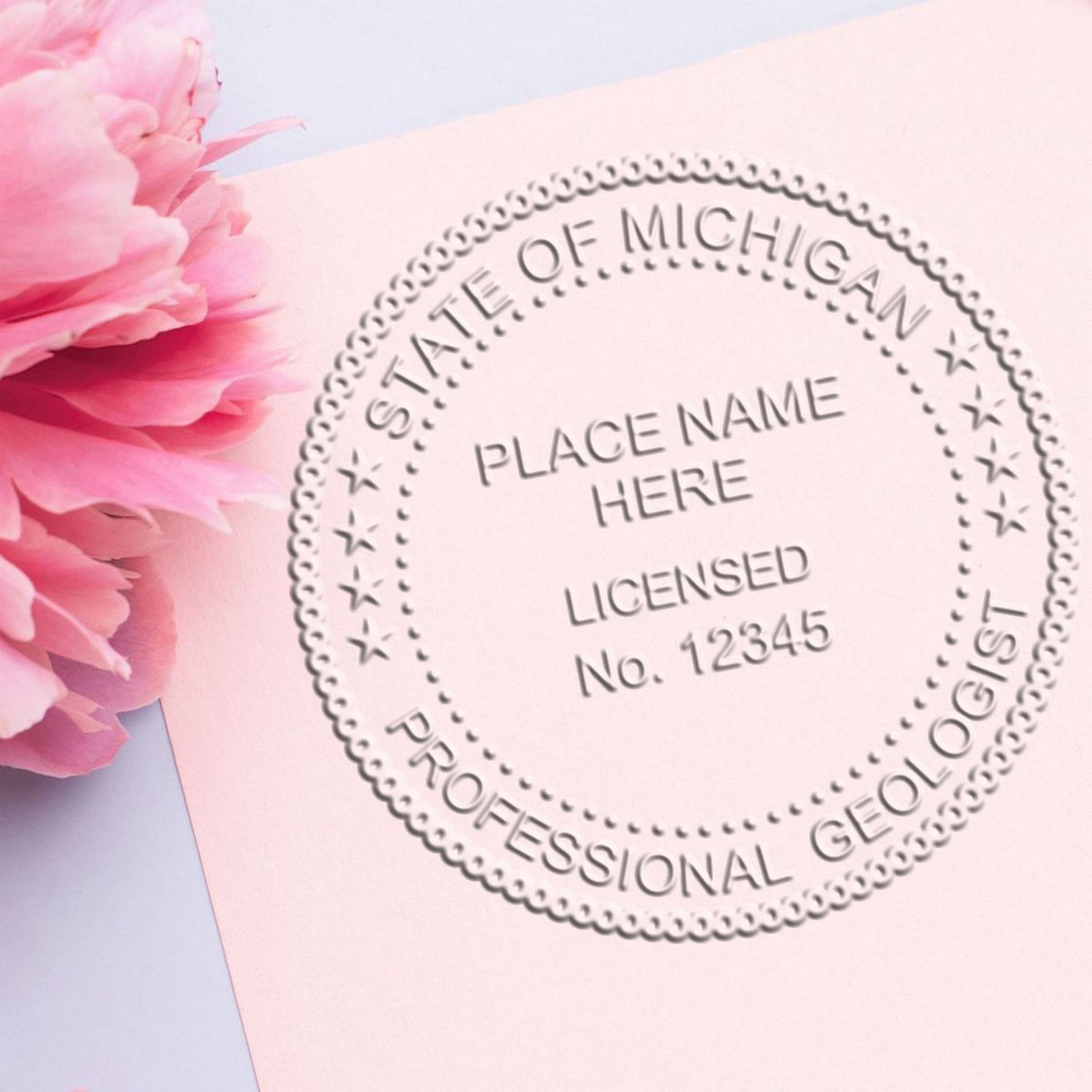 An in use photo of the Soft Michigan Professional Geologist Seal showing a sample imprint on a cardstock