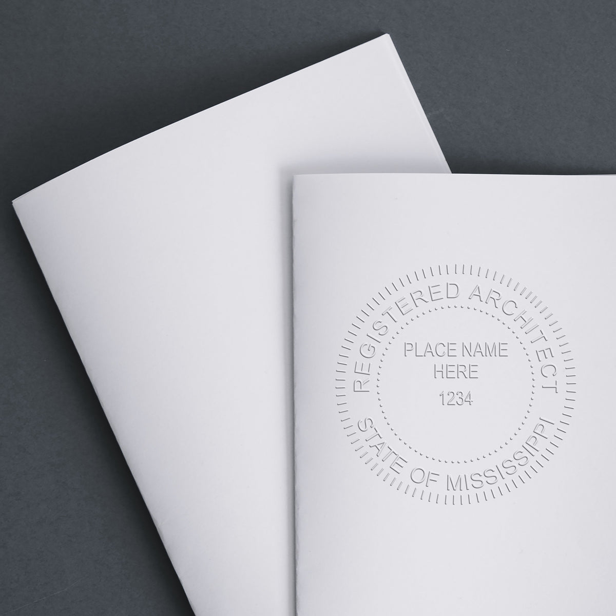 This paper is stamped with a sample imprint of the Handheld Mississippi Architect Seal Embosser, signifying its quality and reliability.