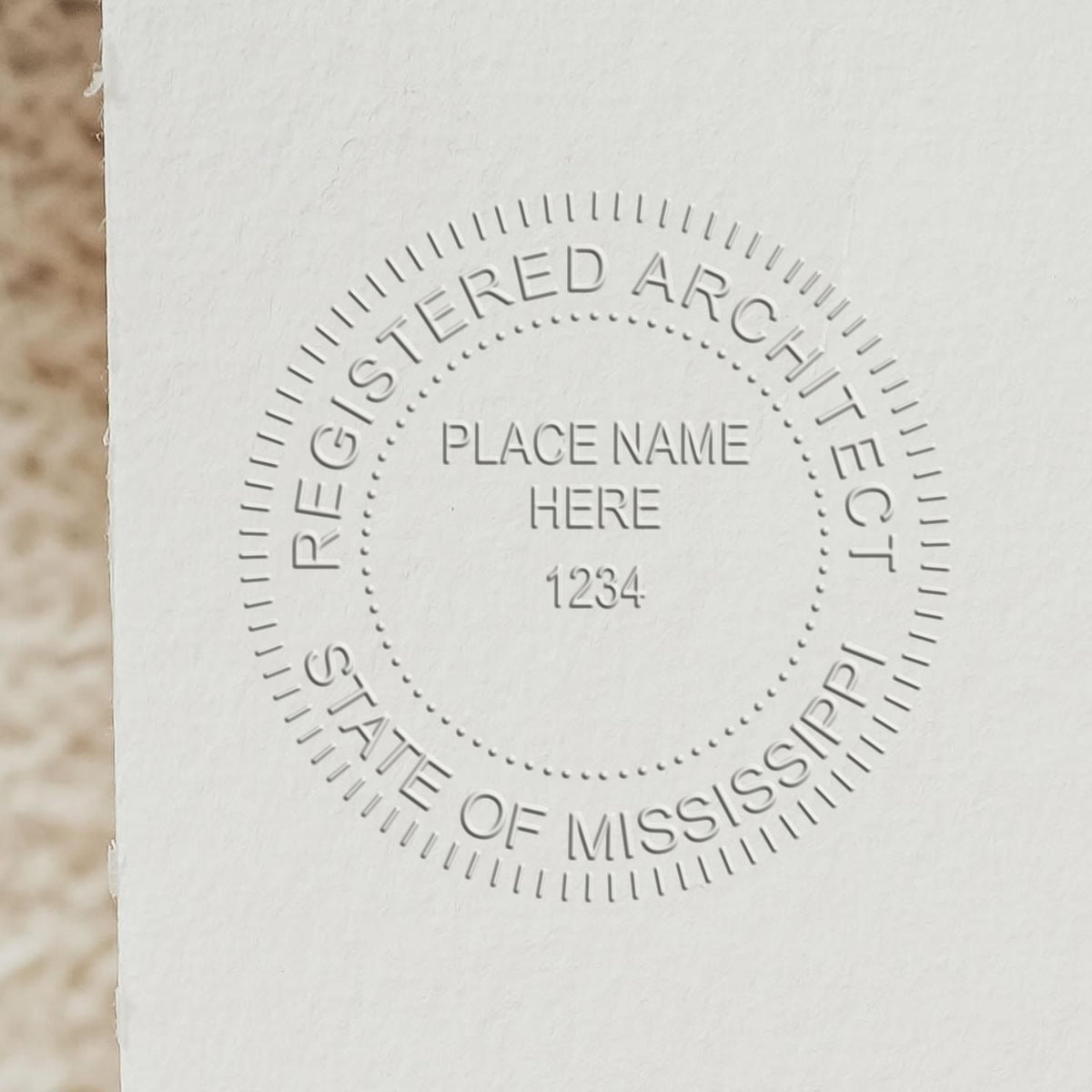 A lifestyle photo showing a stamped image of the Handheld Mississippi Architect Seal Embosser on a piece of paper