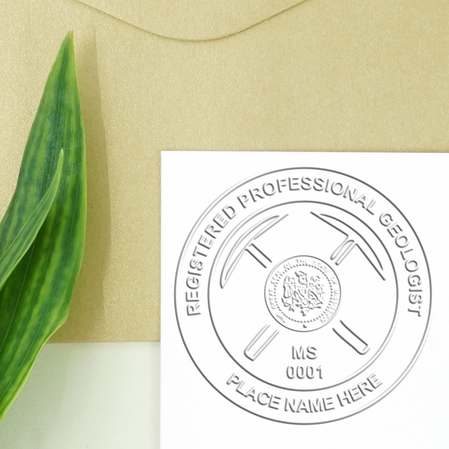 A lifestyle photo showing a stamped image of the Heavy Duty Cast Iron Mississippi Geologist Seal Embosser on a piece of paper