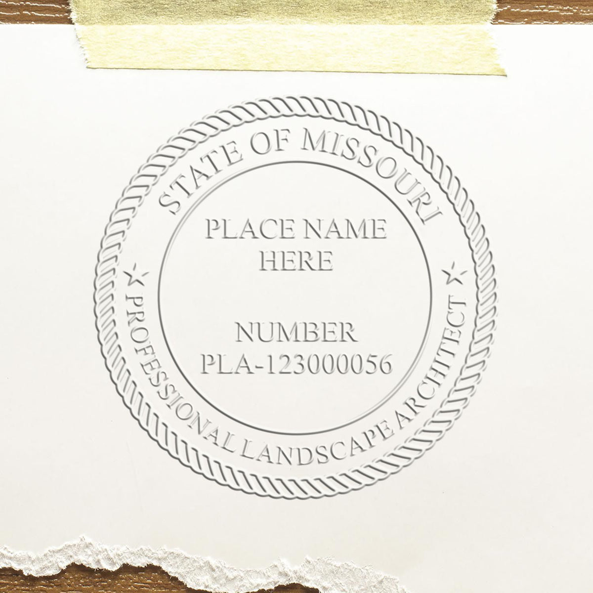 An in use photo of the Hybrid Missouri Landscape Architect Seal showing a sample imprint on a cardstock