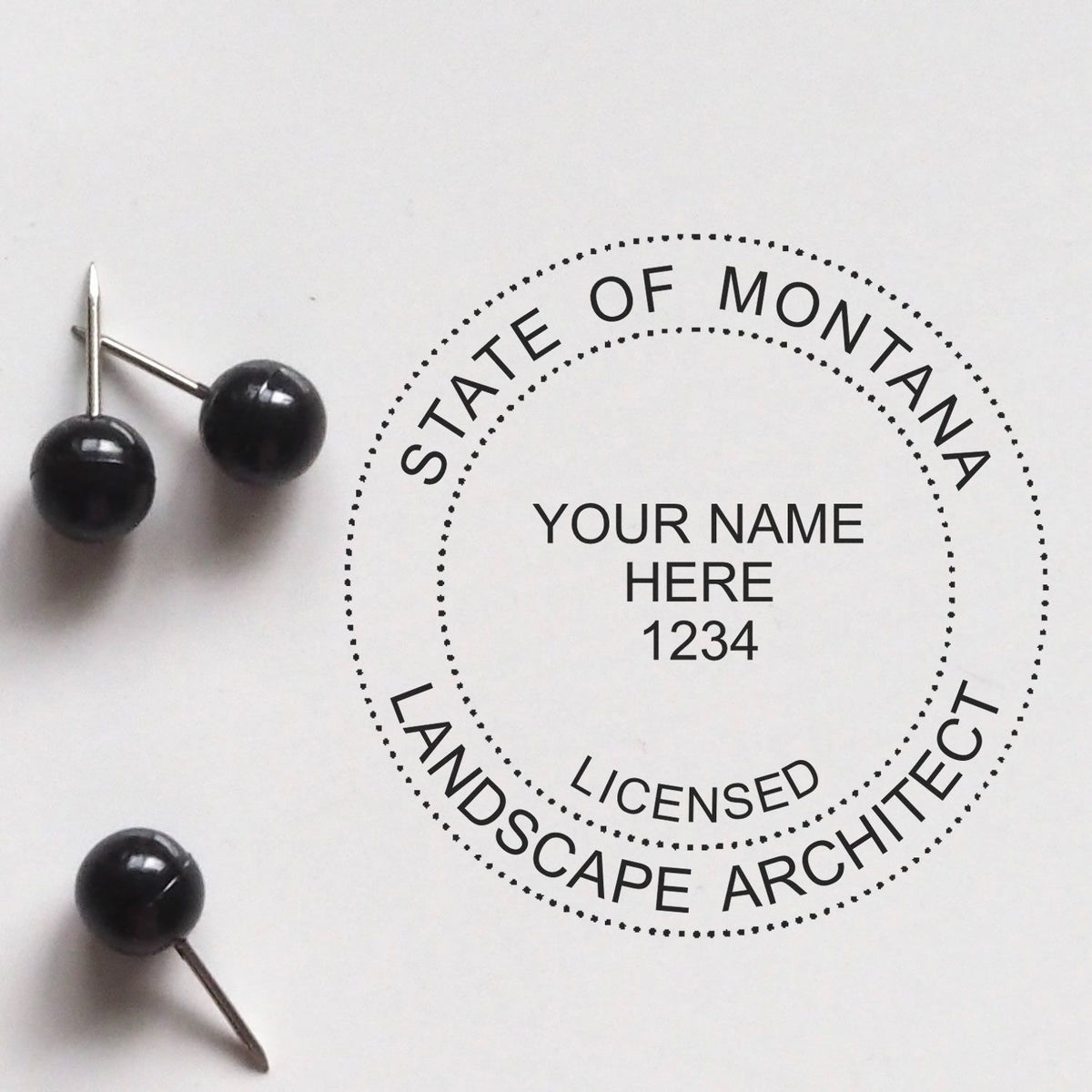 A lifestyle photo showing a stamped image of the Digital Montana Landscape Architect Stamp on a piece of paper