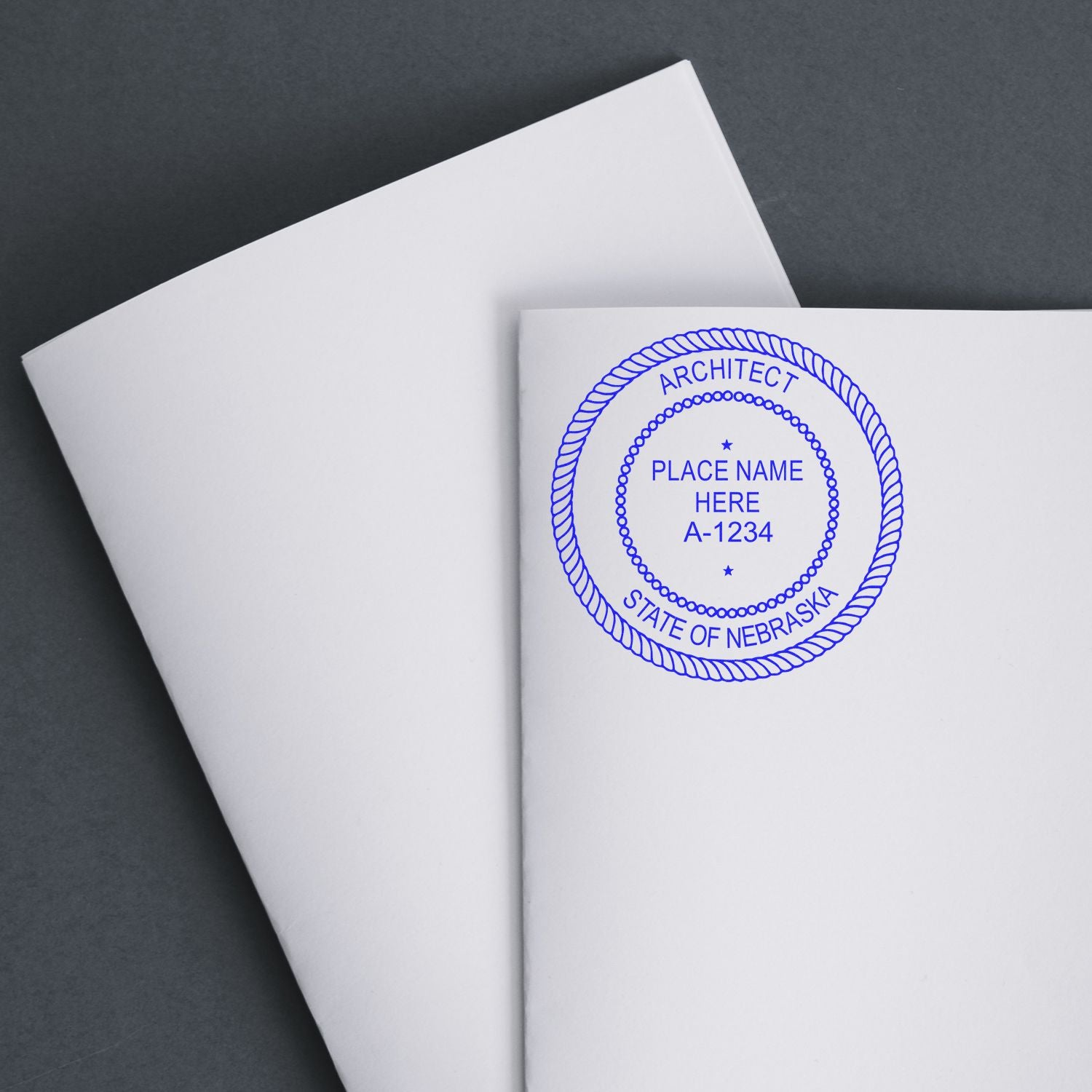 Premium MaxLight Pre-Inked Nebraska Architectural Stamp in blue ink on white paper, showing a circular design with customizable text.