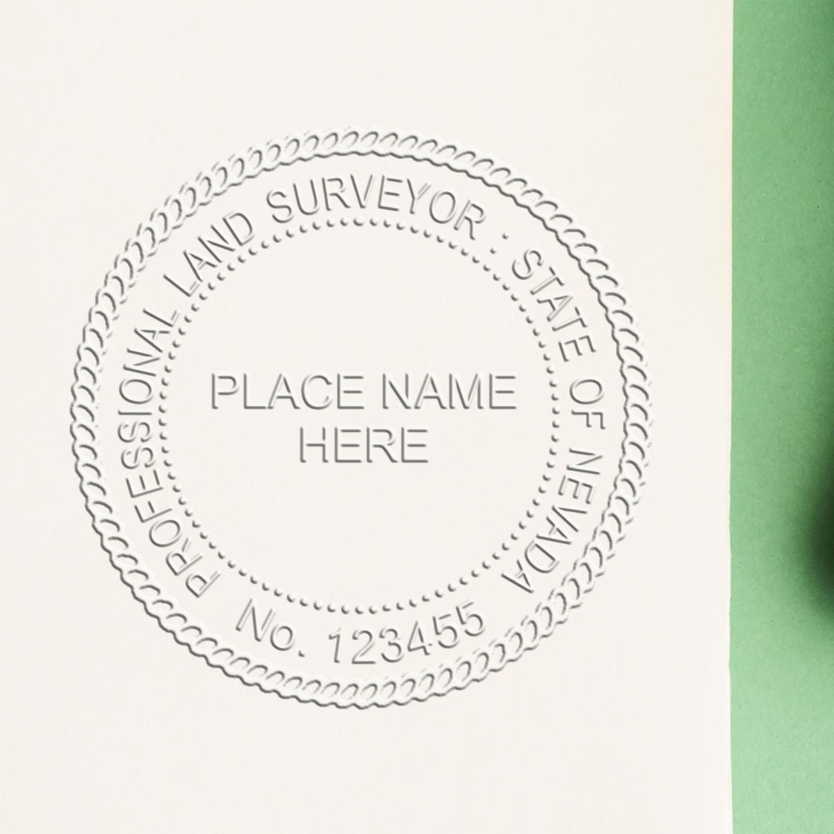 An in use photo of the Hybrid Nevada Land Surveyor Seal showing a sample imprint on a cardstock