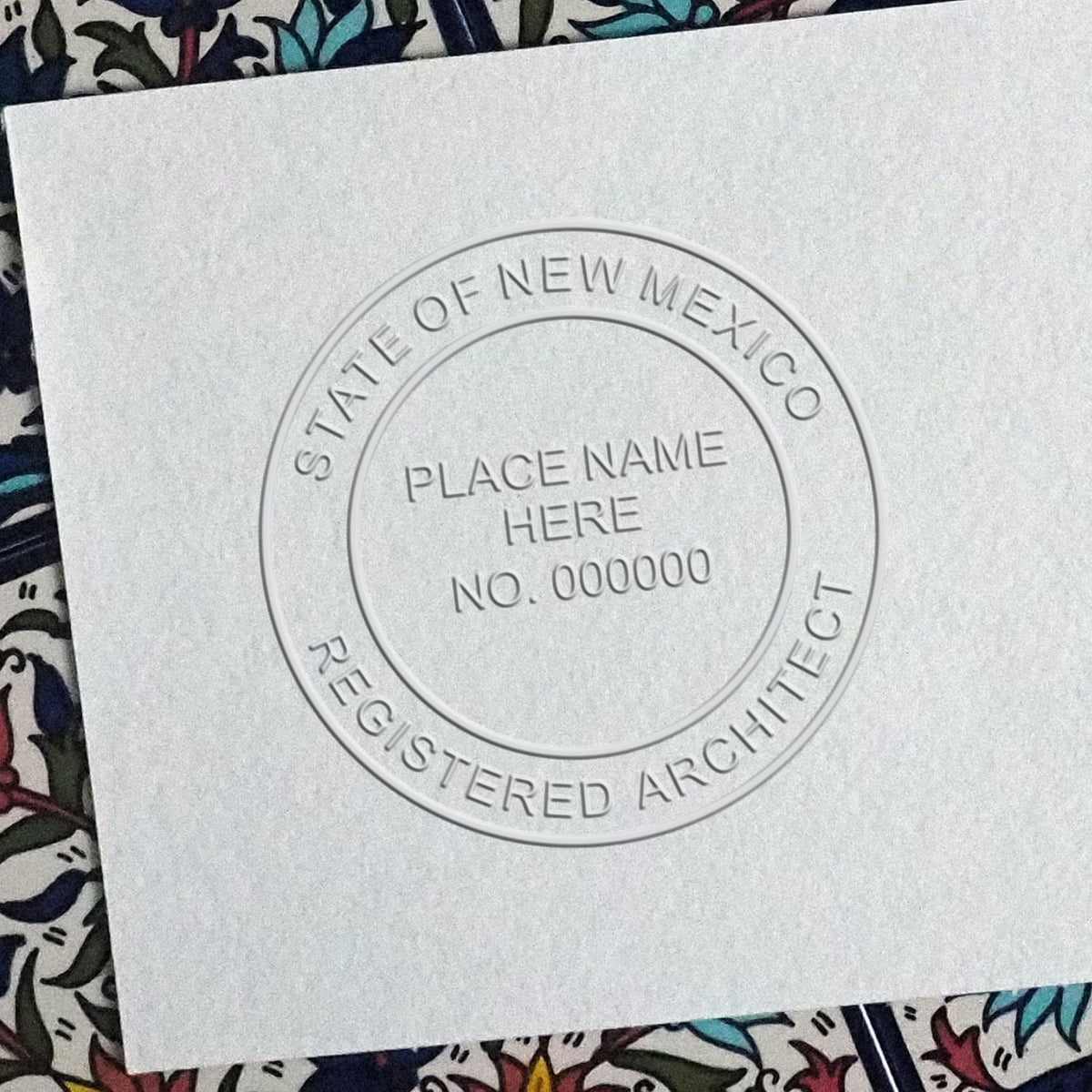 A lifestyle photo showing a stamped image of the New Mexico Desk Architect Embossing Seal on a piece of paper