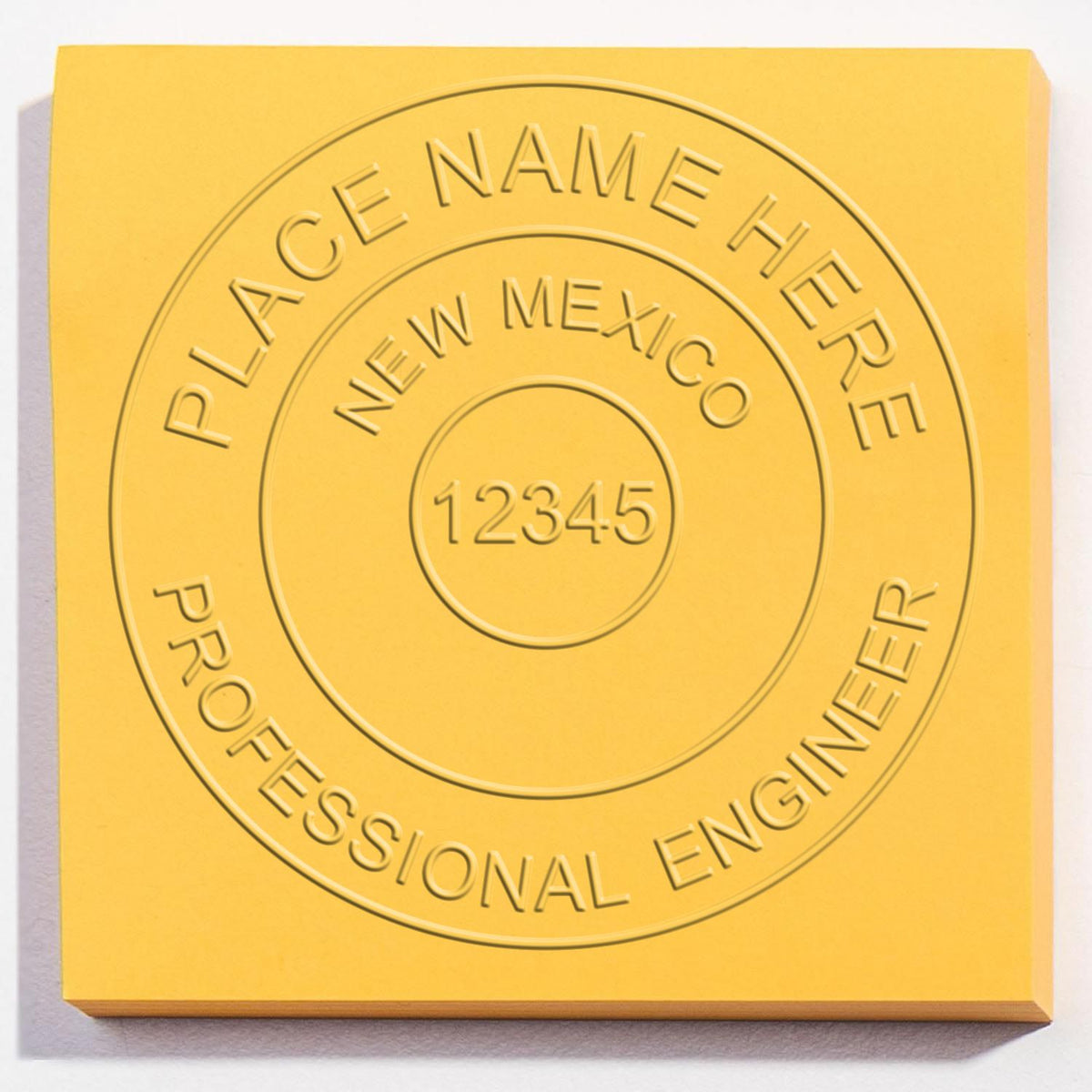 An alternative view of the Heavy Duty Cast Iron New Mexico Engineer Seal Embosser stamped on a sheet of paper showing the image in use