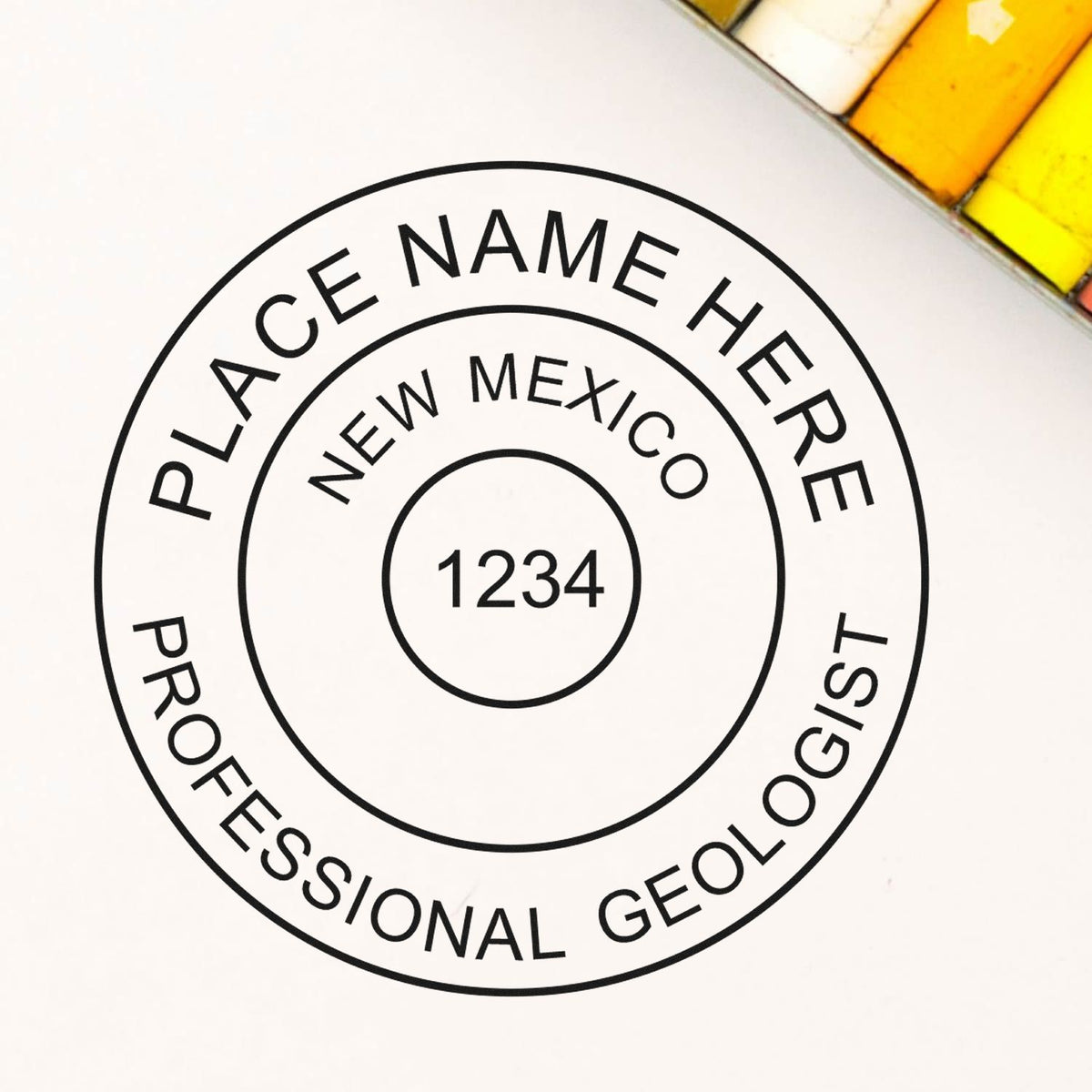 An in use photo of the Self-Inking New Mexico Geologist Stamp showing a sample imprint on a cardstock