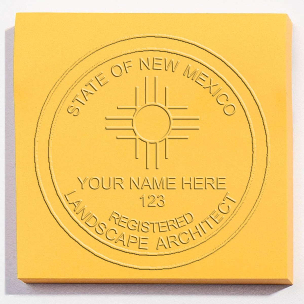 An in use photo of the Hybrid New Mexico Landscape Architect Seal showing a sample imprint on a cardstock