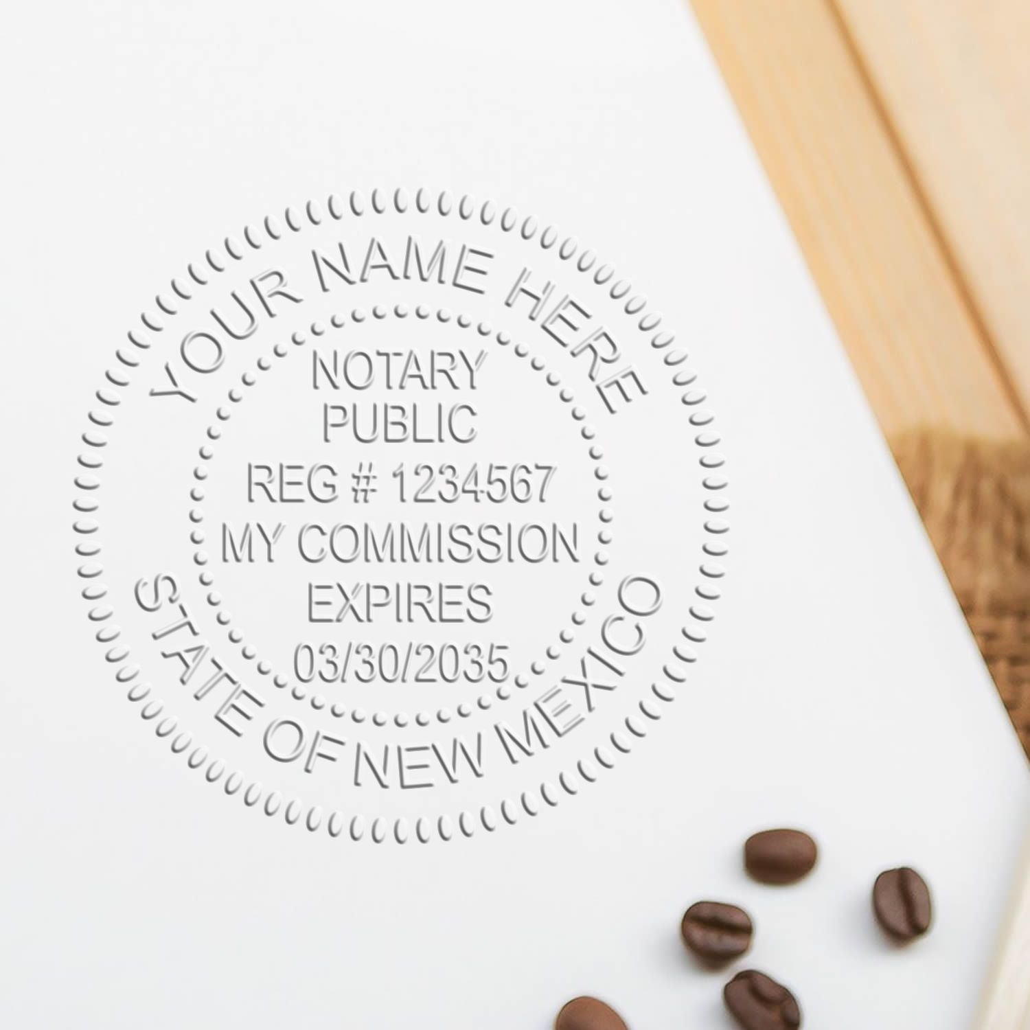 New Mexico Handheld Notary Seal Embosser imprint on white paper with coffee beans nearby.