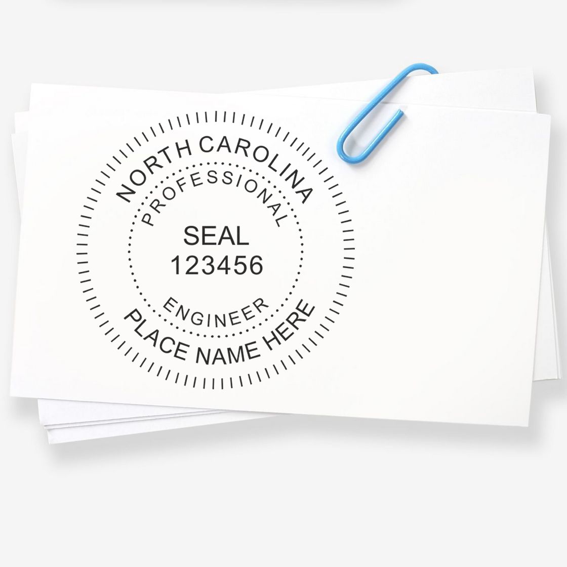 A lifestyle photo showing a stamped image of the Slim Pre-Inked North Carolina Professional Engineer Seal Stamp on a piece of paper