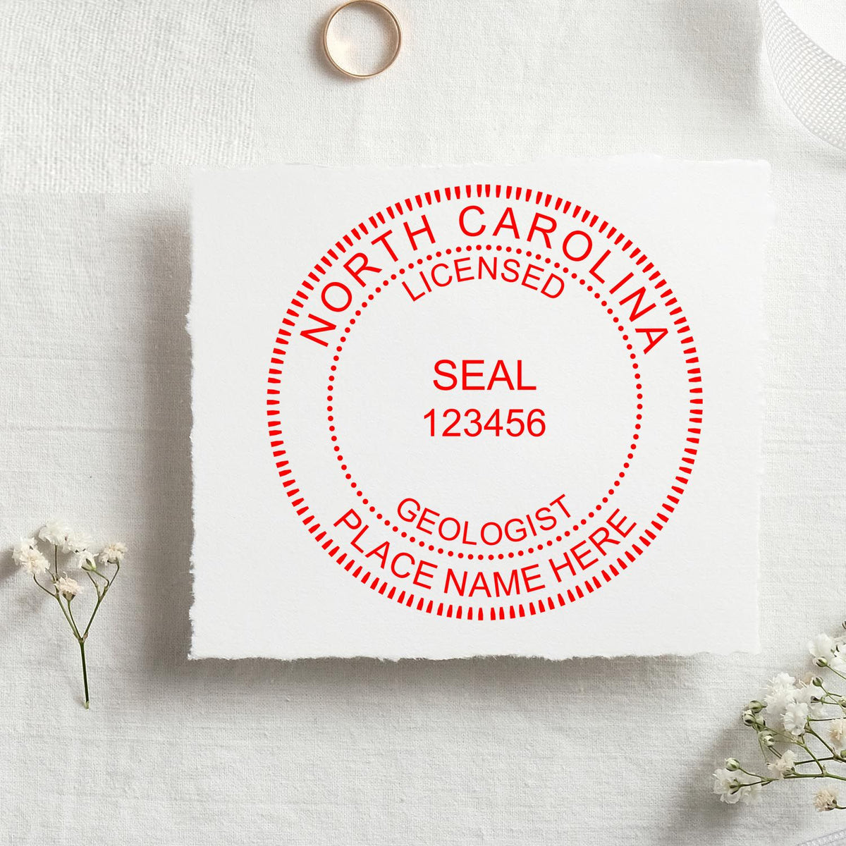 A stamped imprint of the Slim Pre-Inked North Carolina Professional Geologist Seal Stamp in this stylish lifestyle photo, setting the tone for a unique and personalized product.