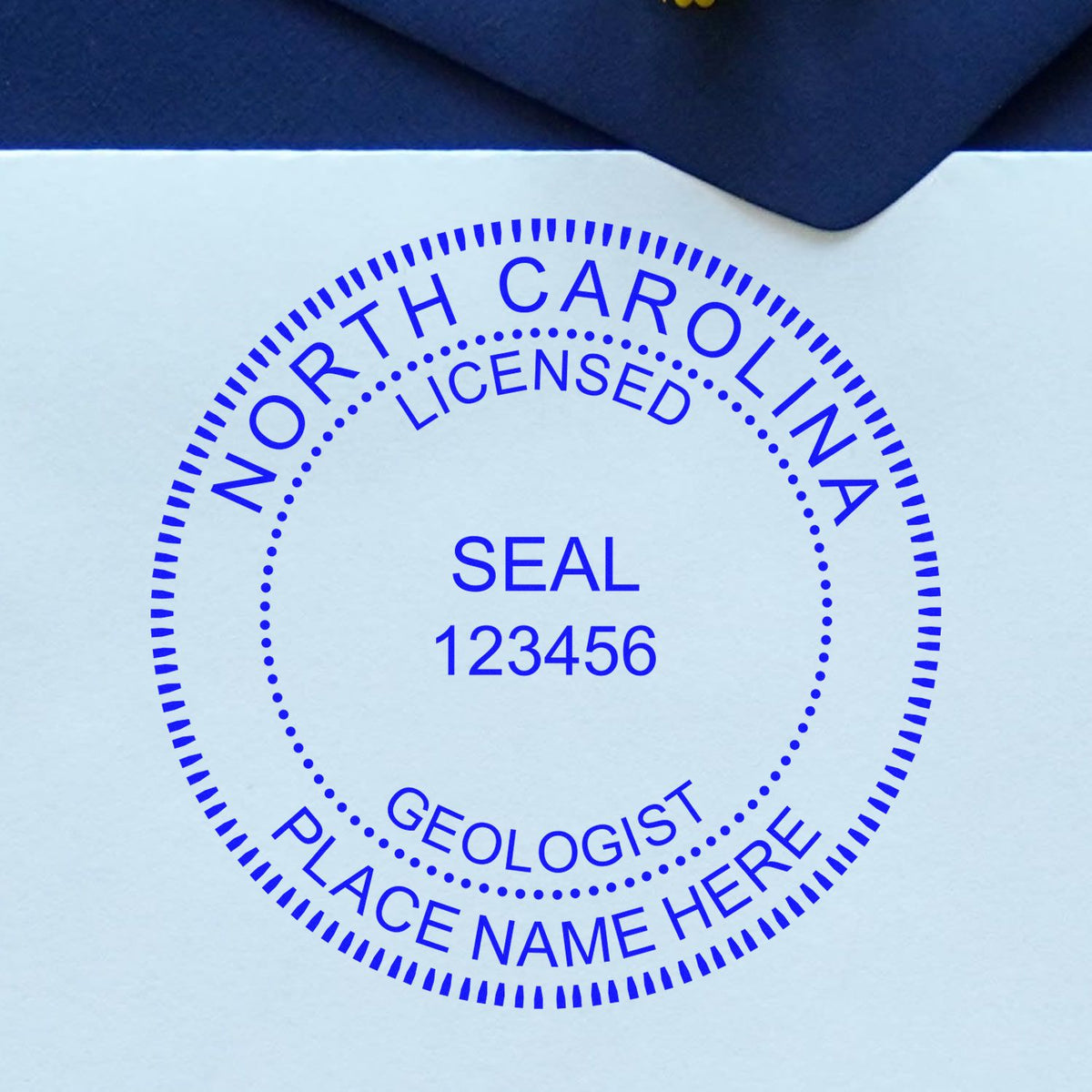 An alternative view of the Slim Pre-Inked North Carolina Professional Geologist Seal Stamp stamped on a sheet of paper showing the image in use
