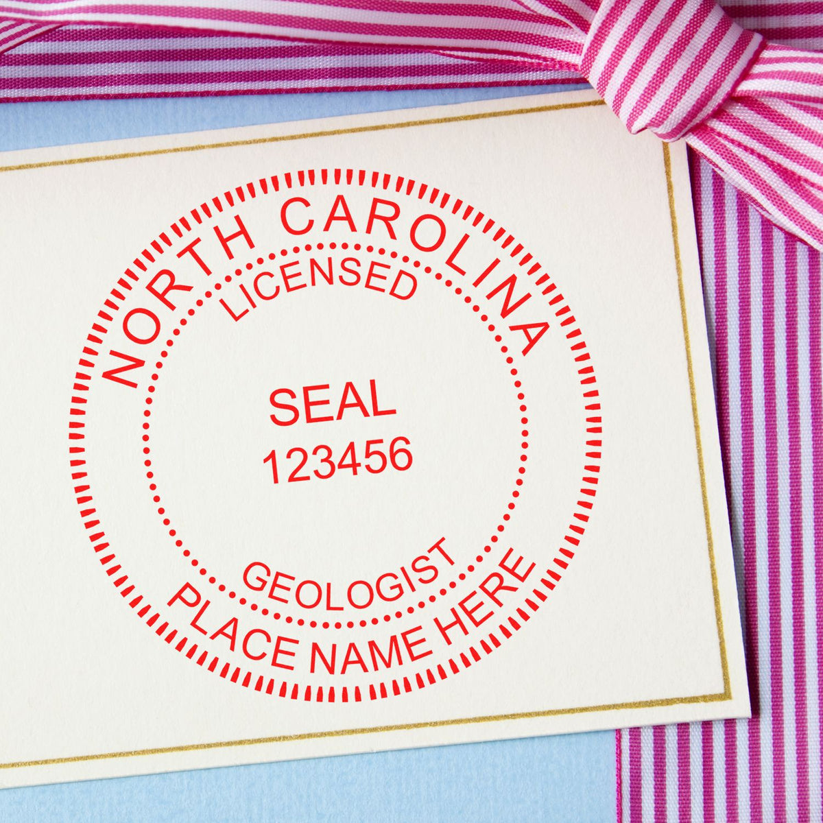 An in use photo of the Slim Pre-Inked North Carolina Professional Geologist Seal Stamp showing a sample imprint on a cardstock
