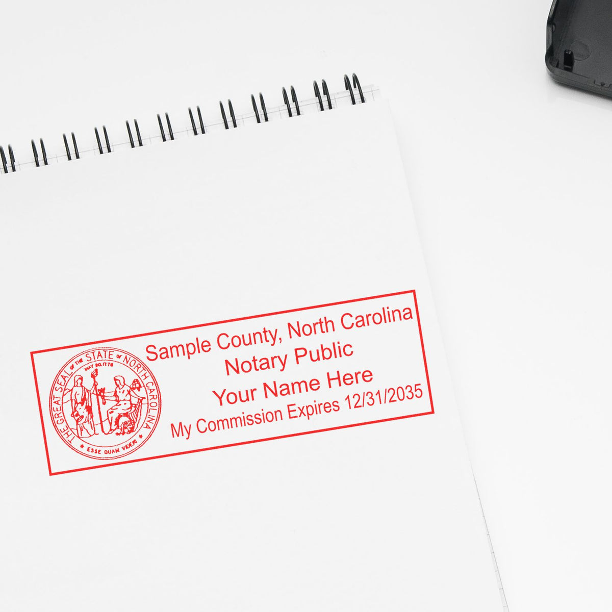 An alternative view of the Slim Pre-Inked State Seal Notary Stamp for North Carolina stamped on a sheet of paper showing the image in use