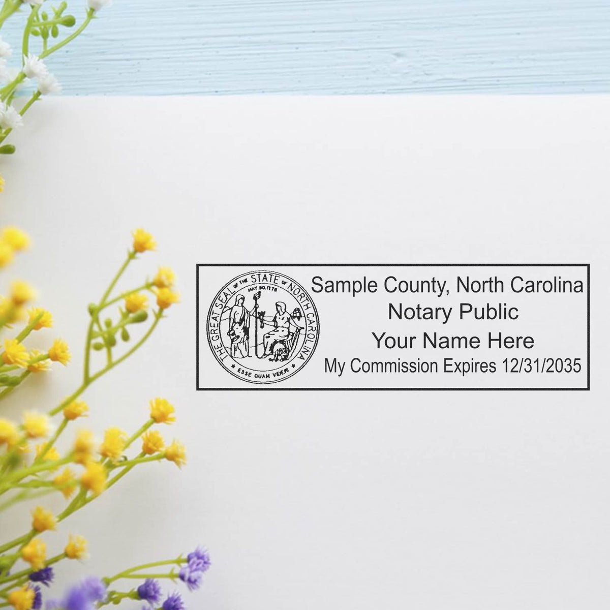 A lifestyle photo showing a stamped image of the Heavy-Duty North Carolina Rectangular Notary Stamp on a piece of paper