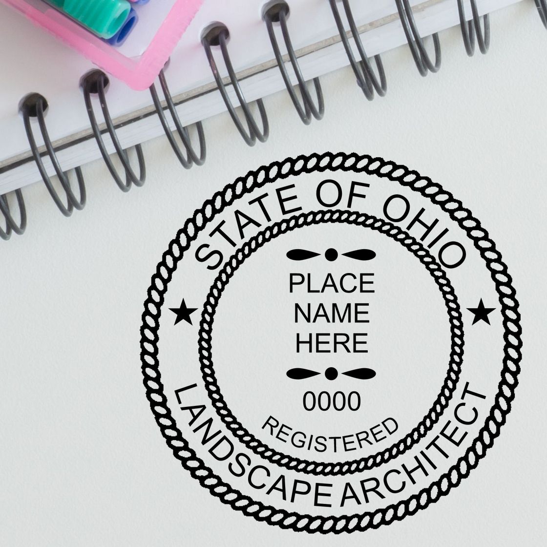 A lifestyle photo showing a stamped image of the Digital Ohio Landscape Architect Stamp on a piece of paper