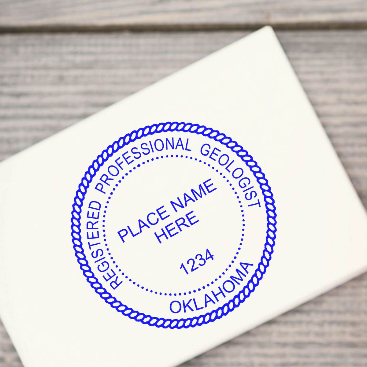 An alternative view of the Slim Pre-Inked Oklahoma Professional Geologist Seal Stamp stamped on a sheet of paper showing the image in use