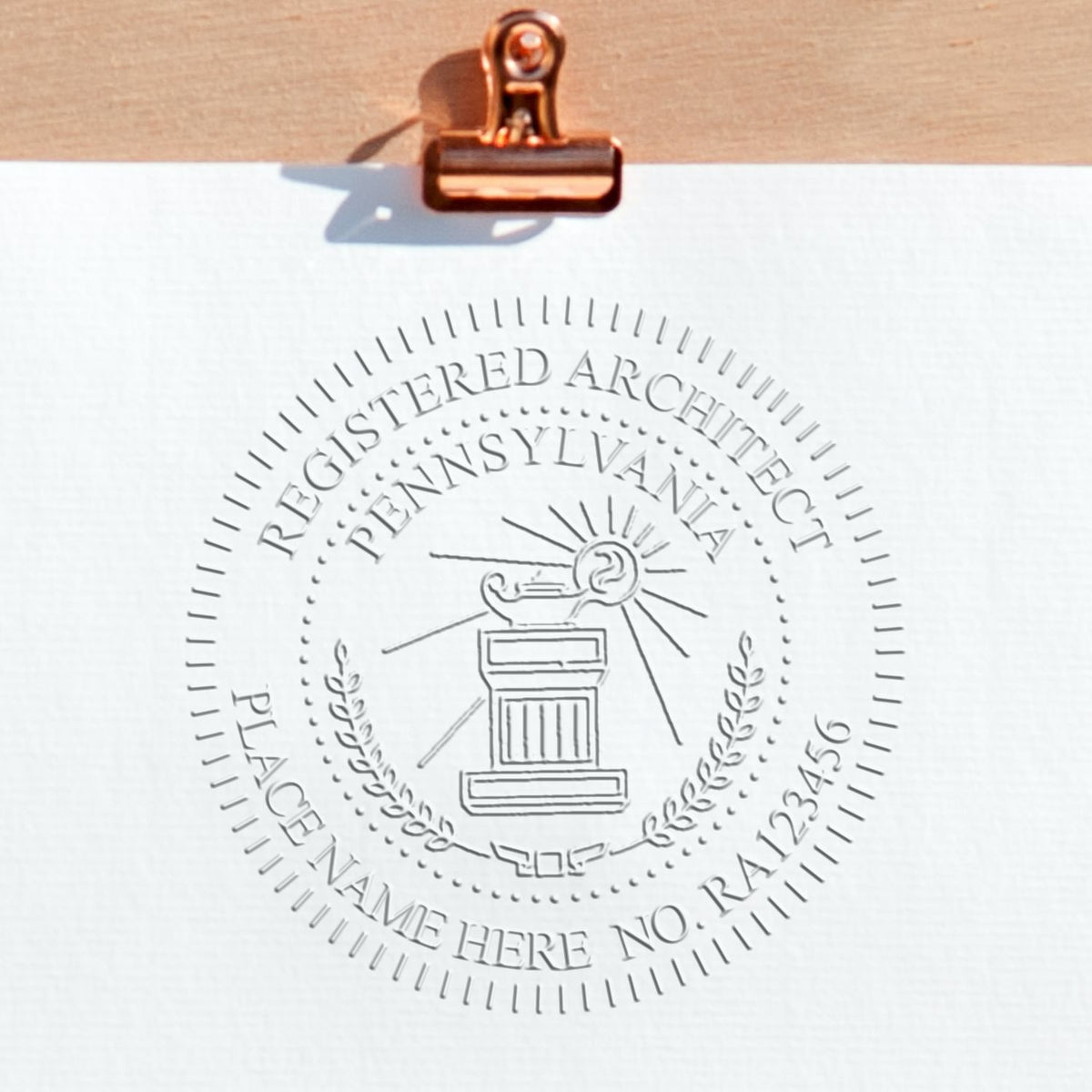 A stamped impression of the State of Pennsylvania Architectural Seal Embosser in this stylish lifestyle photo, setting the tone for a unique and personalized product.