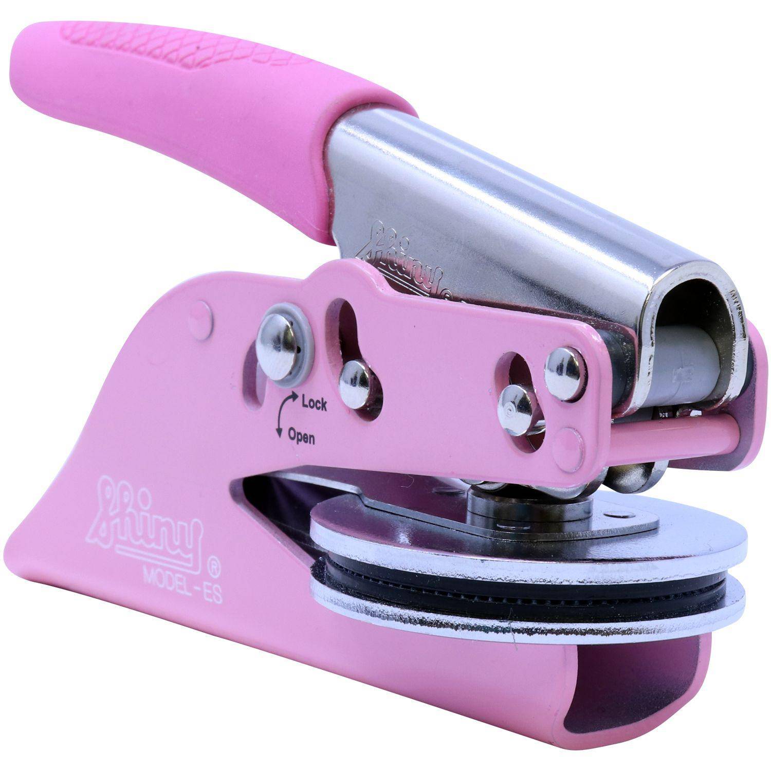 Pink handheld embosser with a soft grip handle, labeled Engineering Geologist Pink Soft Seal Embosser. The device is shown from a side angle, highlighting its metal components and locking mechanism.