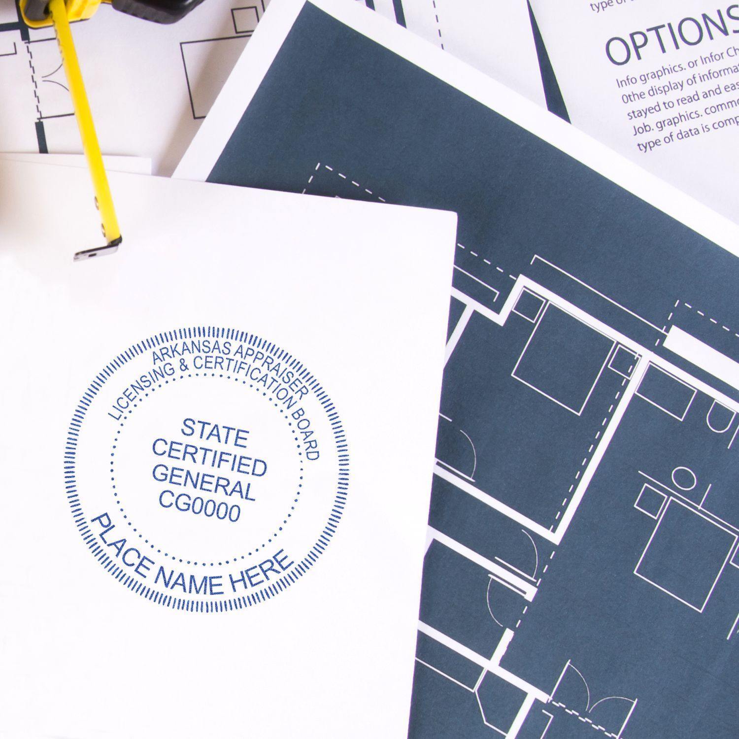 Real Estate Appraiser MaxLight Pre Inked Rubber Stamp of Seal in use on a document, with architectural blueprints in the background.