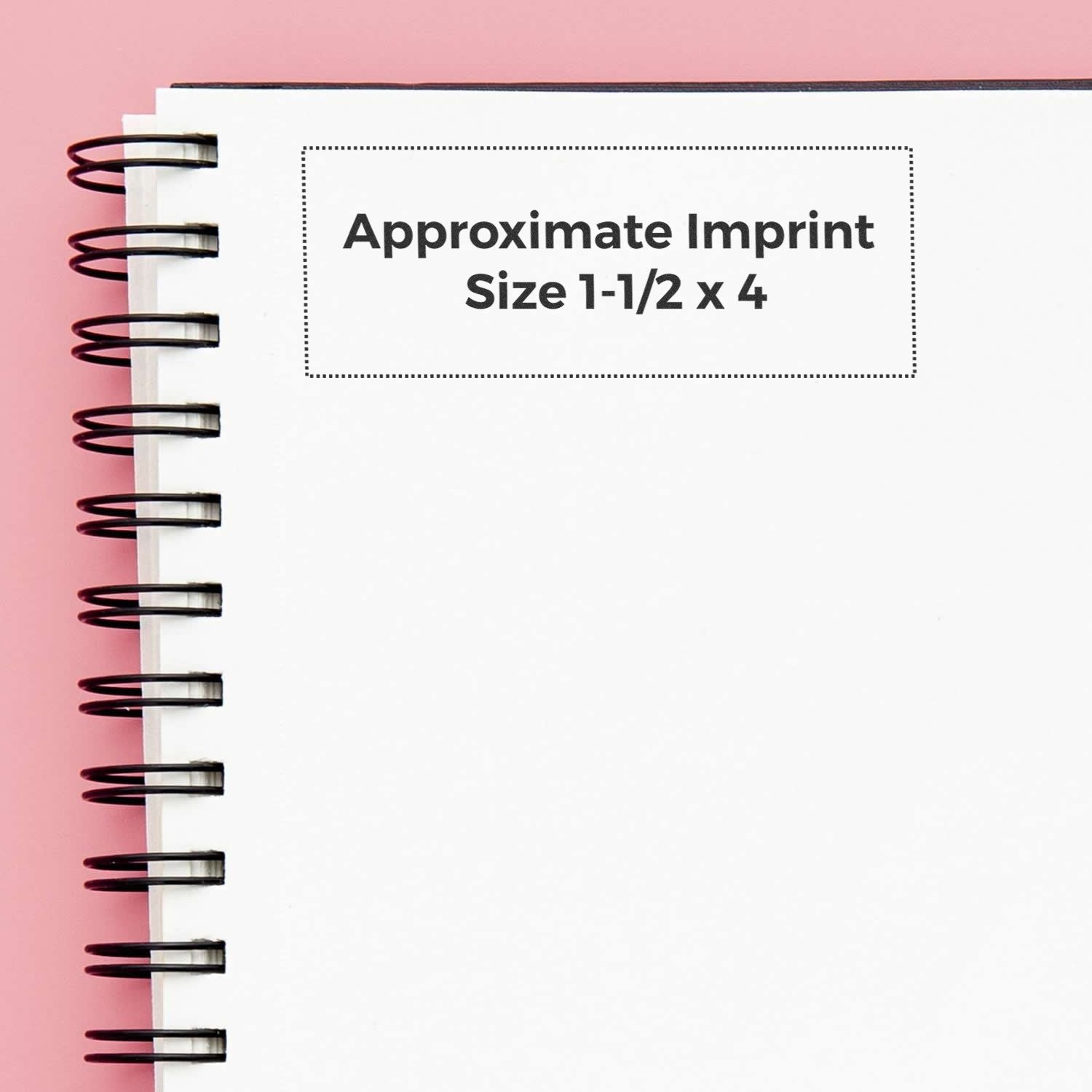 Custom Rubber Stamp Size 1-1/2 x 4 shown on a spiral notebook with a pink background, displaying the approximate imprint size.
