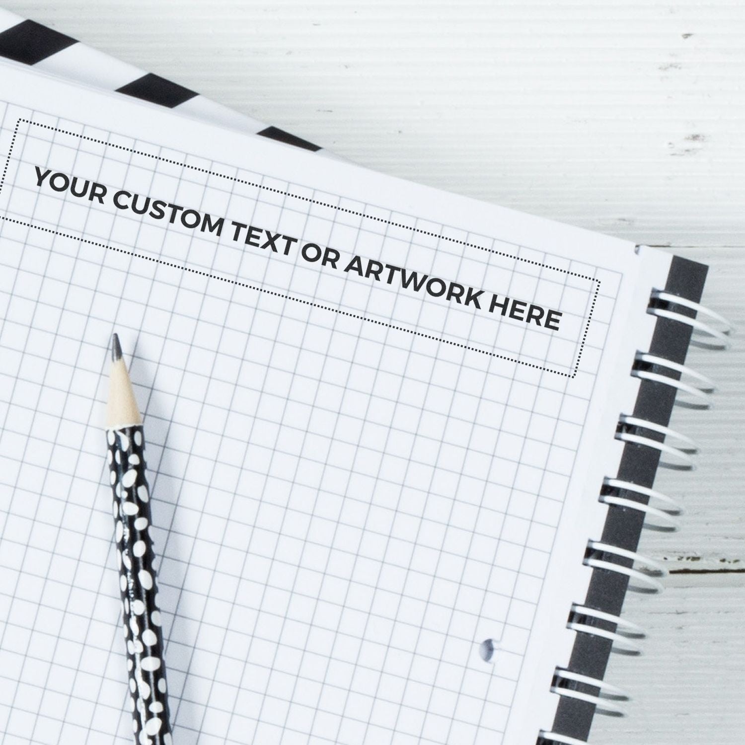 Custom Rubber Stamp Size 1-1/2 x 8 used on a grid notebook page with a black and white pencil placed diagonally.