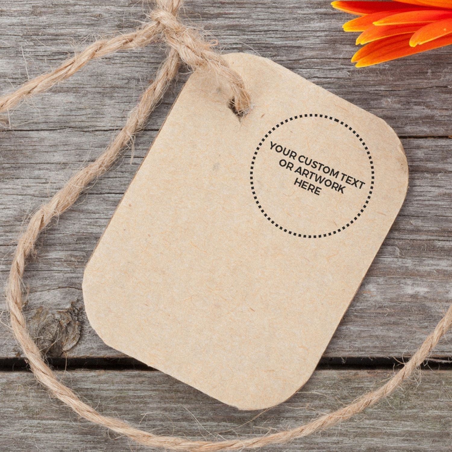 Custom Rubber Stamp Size 1/2 Inch Diameter used on a brown tag with twine, placed on a wooden surface with an orange flower petal.