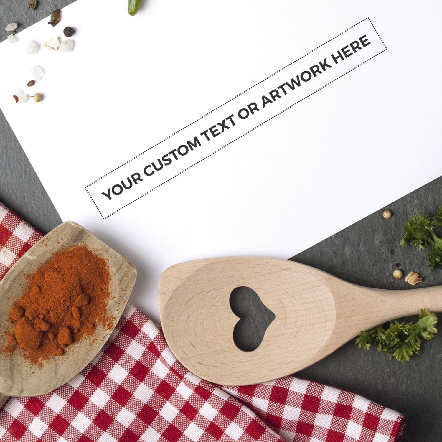 Custom Rubber Stamp Size 1 x 9 stamped on white paper, surrounded by a wooden spoon, spices, and a red checkered cloth.