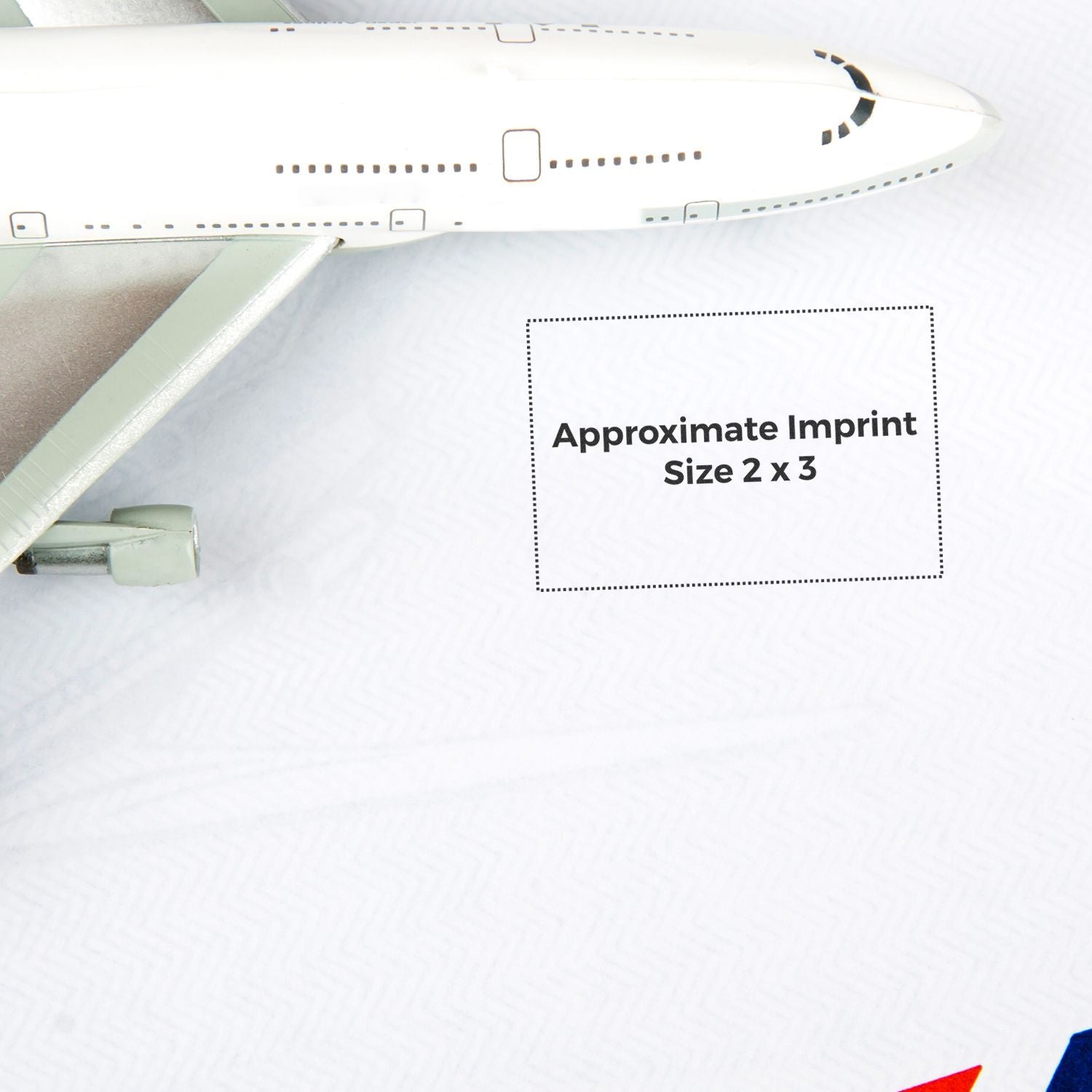 Image of a Custom Rubber Stamp Size 2 x 3 with an airplane model in the background and text indicating the approximate imprint size.