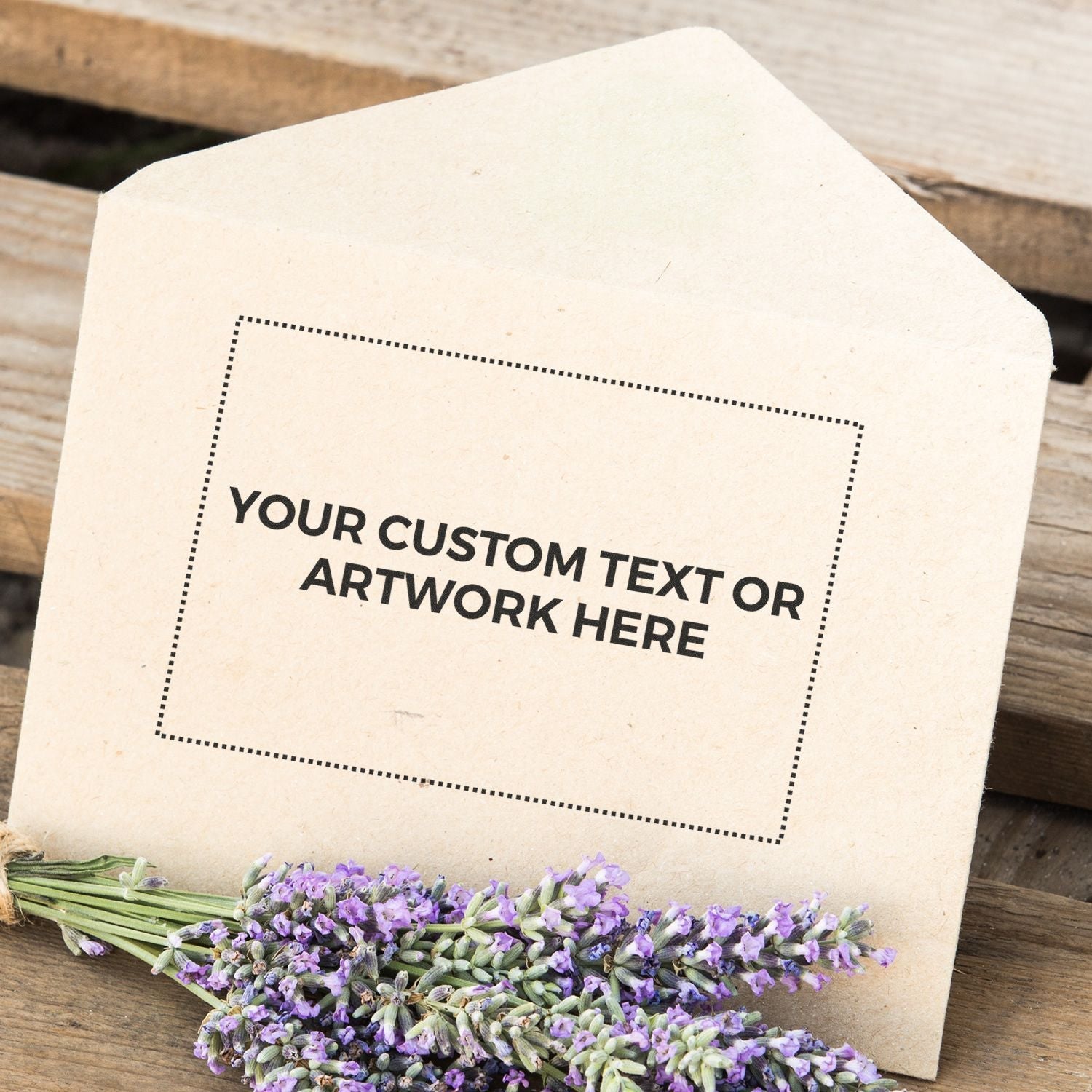 Envelope stamped with Your Custom Text or Artwork Here using Custom Rubber Stamp Size 2 x 3, with lavender flowers placed beside it.