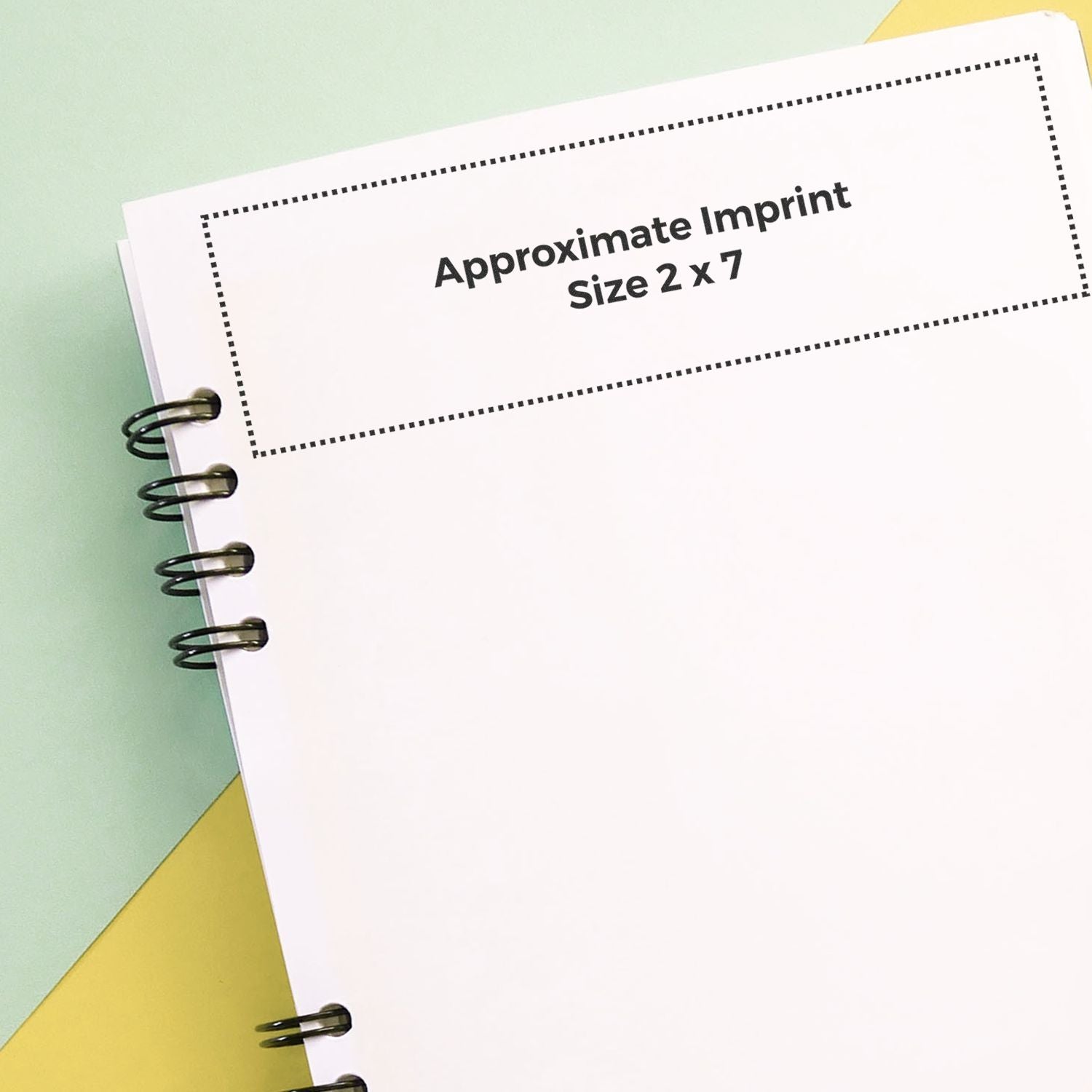 Custom Rubber Stamp Size 2 x 7 shown on a white notebook page with approximate imprint size indicated by a dotted rectangle.