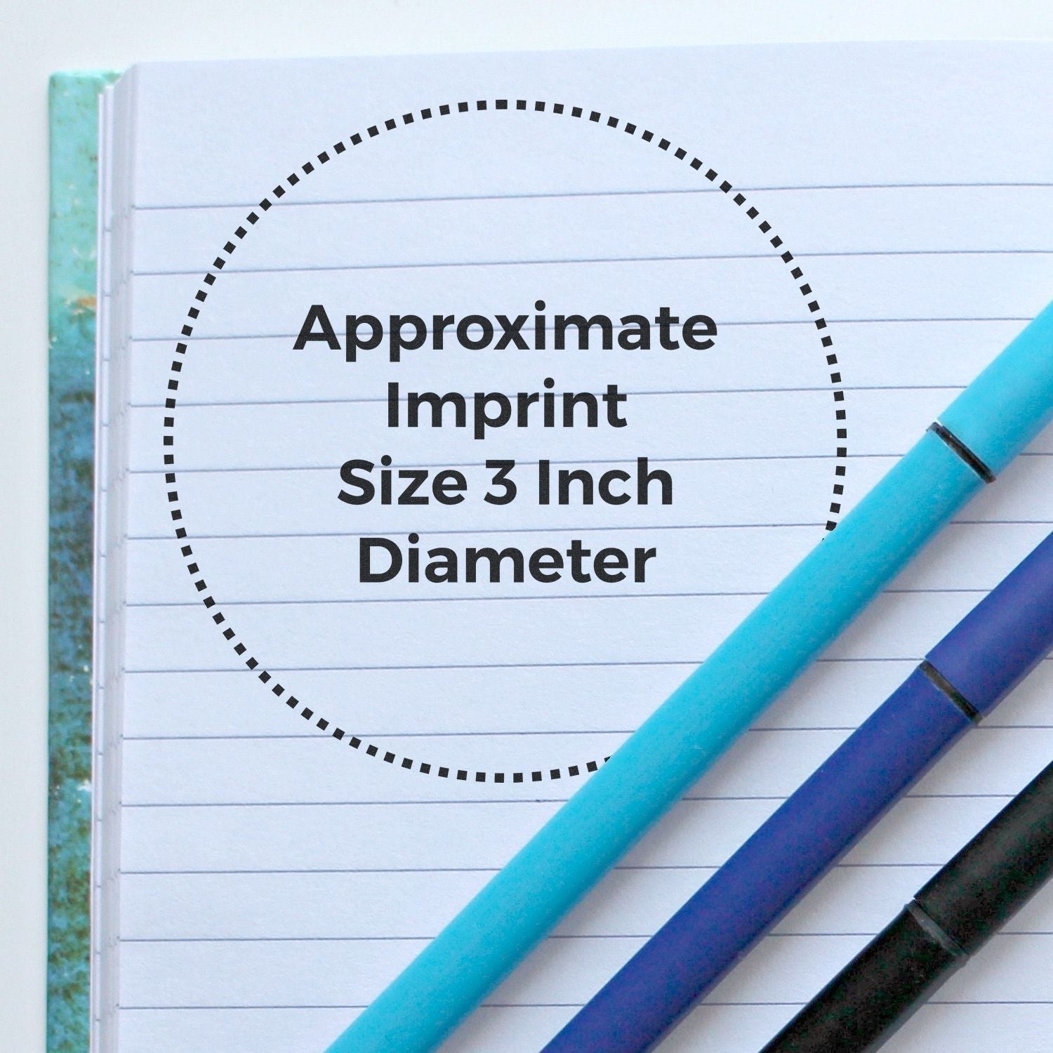 Custom Rubber Stamp Size 3 Inch Diameter shown on a lined notebook with blue and black pens beside it.