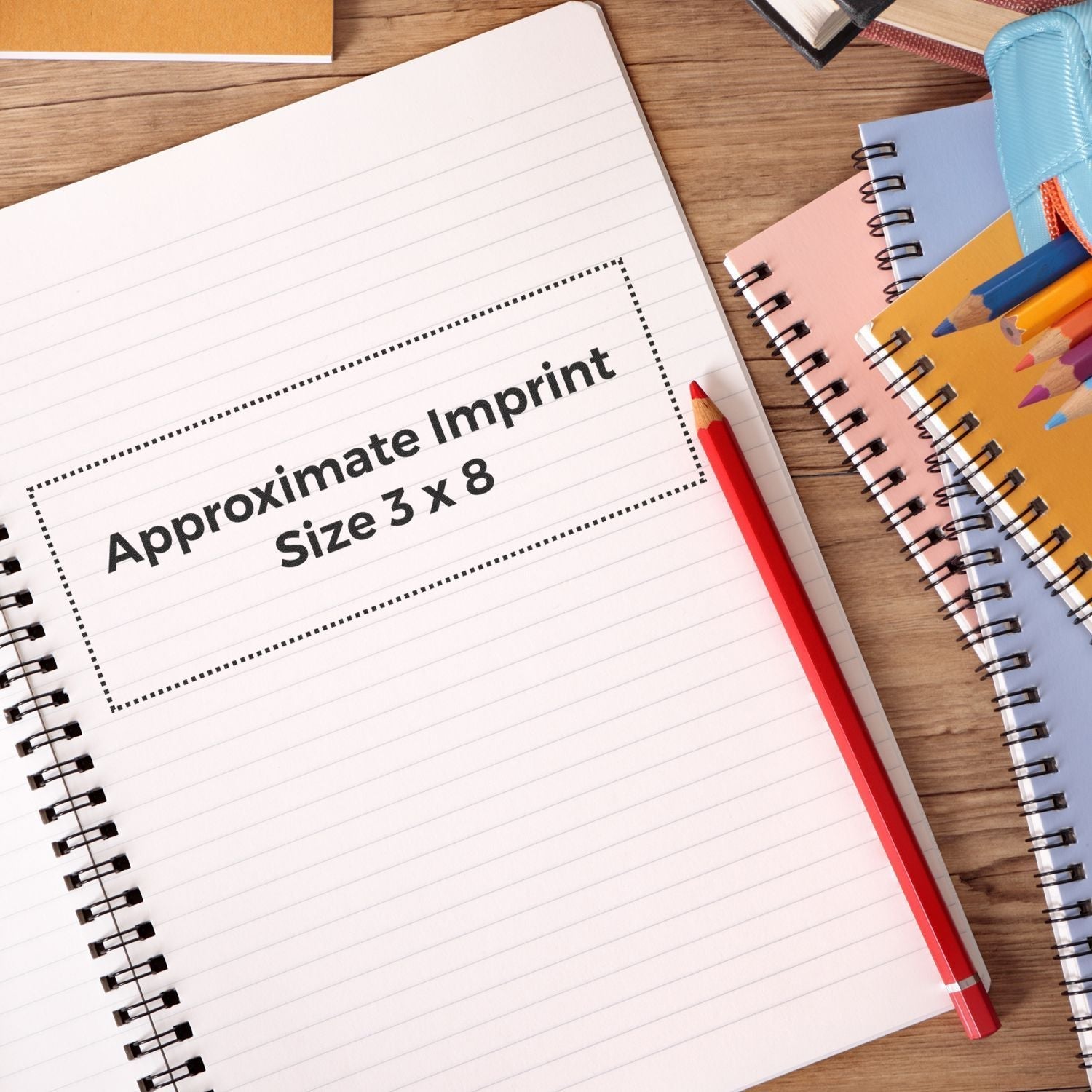 Custom Rubber Stamp Size 3 x 8 shown on a notebook page with a red pencil and colorful stationery on a wooden desk.