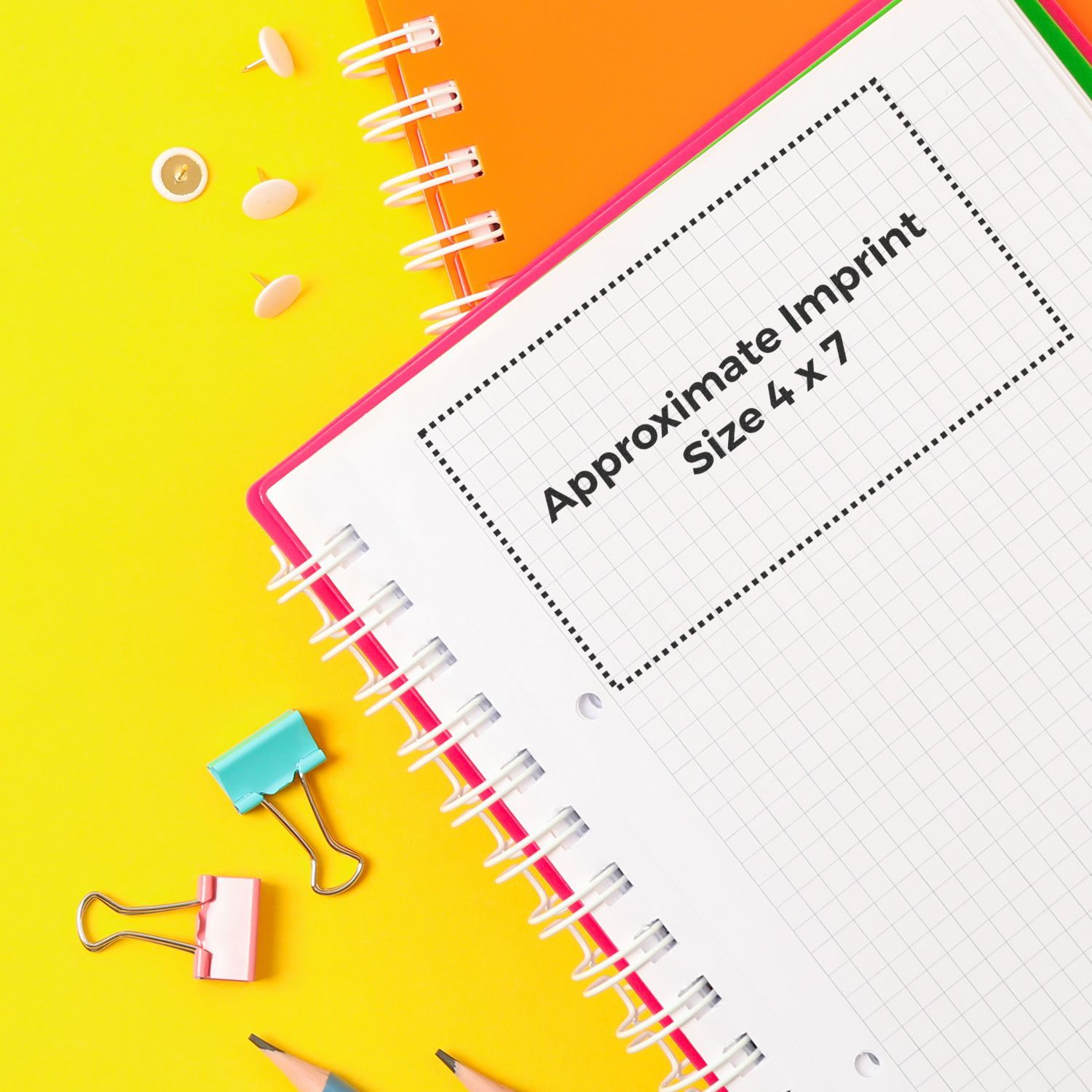 Custom Rubber Stamp Size 4 x 7 displayed on a notebook with grid paper, surrounded by office supplies on a vibrant yellow and orange background.